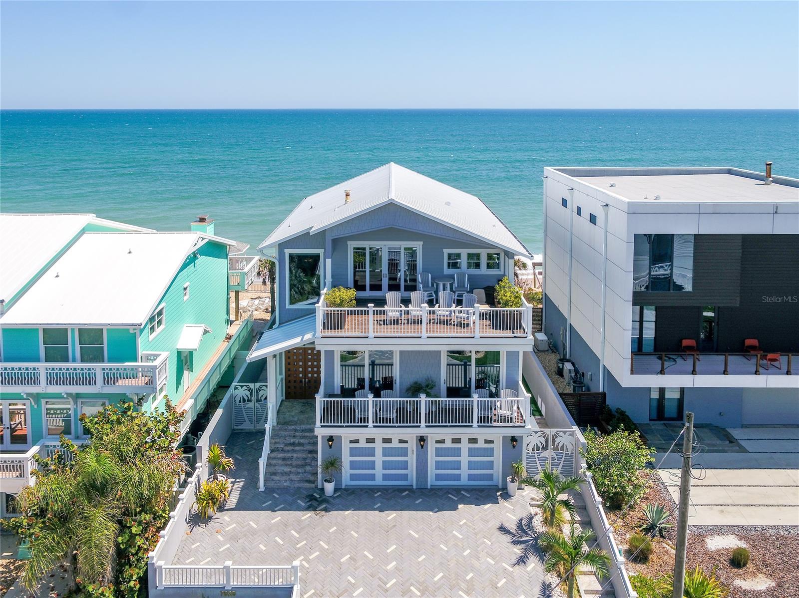 THE RETREAT OF A LIFETIME. From the river to the sea, an inheritable estate in beloved NSB for the most discerning of buyers. A tri-parcel, one-of-a-kind home, comes fully renovated and ***FURNISHED*** for your dream getaway at the beach. Thoughtfulness and detail make this not only ergonomic, but seamless at every turn. RH chandeliers illuminate the living spaces along with a custom Lutron lighting and Sonos sound systems for creating the perfect ambiance. Anderson impact windows and hideaway sliders frame your views, complemented by remote blinds and curtains for privacy and efficiency. RELAX in your oceanfront oasis to include a heated and jetted custom pool with IPÉ decking and a grandfathered gazebo overlooking the commanding surf. Luxury gathering kitchen featuring dual kitchen islands, Sub-Zero refrigerator's and drawers, WOLF gas stove, double silent dishwashers, and honed marble slab countertops and backsplash. Everything has been meticulously thought out, nothing overlooked. Showstopper owner suite with East & West decks for sunrise to sunset penthouse vistas- *ask about the surprise feature. Luxury spa-like bathroom with marble slab shower, as well as a freestanding soaking tub. Custom cabinetry and Italian imported 9" plank hardwood flooring throughout the home. Fully equipped gym, impressive 6 panel theatre, and custom wet bar. Watch the dolphins play or take the kayaks (included) for an afternoon paddle from your COVERED RIVERFRONT boat slip + dock. Packed with intrinsic value- Luxury awaits! ***SEE EXPANDED FEATURES LIST*** Qualifications required prior to tour. ;Water: City