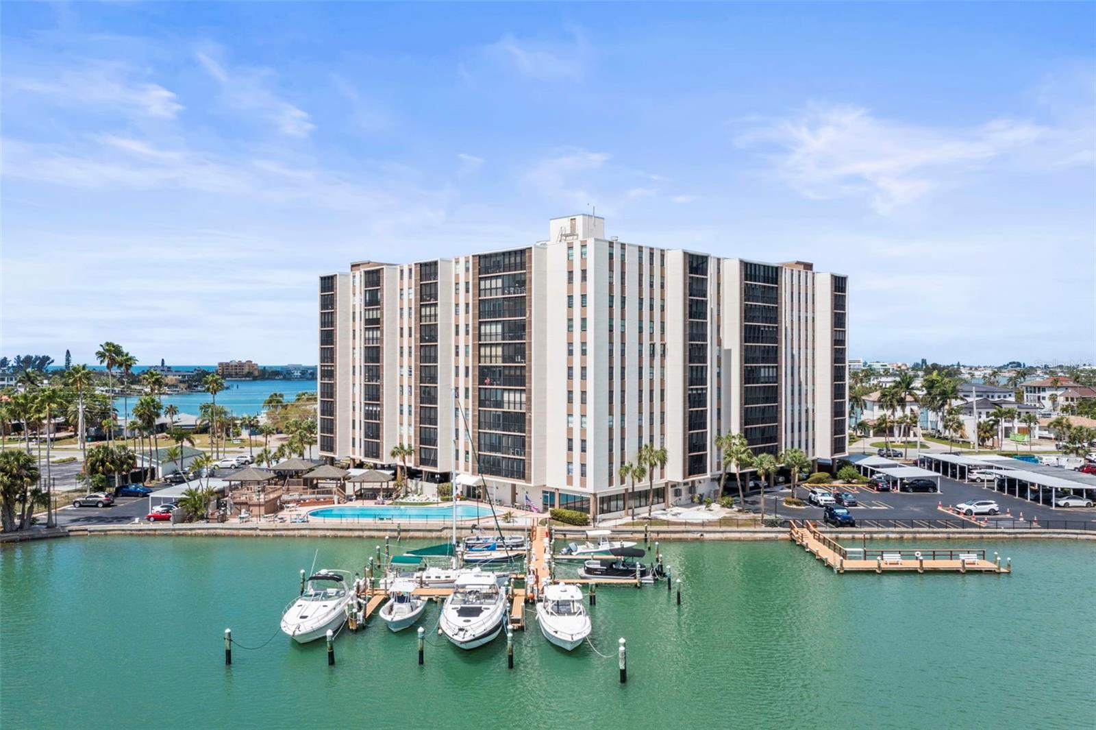 One or more photo(s) has been virtually staged. Wake up to coastal breezes and sweeping water views at this beautifully located condominium in the heart of Treasure Island. Positioned on the 4th floor at Paradise Island Towers, this nicely updated, 2-bedroom, 2-bath residence offers an elevated coastal lifestyle with captivating views and abundant natural light. The interior has been thoughtfully refreshed, featuring an updated kitchen with leather-finish granite countertops and brand-new appliances, creating a clean, modern foundation for both everyday living and entertaining. The open-concept layout flows seamlessly from the kitchen into the dining and living areas, where large sliding glass doors lead to a private balcony - an ideal setting to unwind, take in the coastal breeze, and enjoy coastal sunsets. The primary suite serves as a comfortable retreat with an en-suite bathroom, while the second bedroom and full bath provide flexibility for guests, a home office, or extended stays. The corner unit orientation enhances privacy while maximizing light and views throughout the home. Paradise Island Towers is a well-maintained waterfront community known for its solid construction and great amenities. Residents enjoy a large pool and spa, sun deck, grilling areas, and ample parking. The building also offers secure entry and convenient parking, creating a low-maintenance, lock-and-leave lifestyle. Adding to its appeal, the property is ideally located next to Treasure Bay Golf and Tennis Facility—a unique local amenity offering a fun and challenging 9-hole, par-3 walking course overlooking the Intracoastal Waterway, along with tennis, pickle  ball, shuffleboard, volleyball and basketball courts. It’s a rare lifestyle bonus that brings recreation right to your doorstep. Just a short distance from the sandy beaches of Treasure Island, this residence places you in the center of everything - local restaurants, waterfront dining, entertainment, and the vibrant energy of John’s Pass Village. Downtown St. Petersburg, with its museums, shopping, and nightlife, is a quick drive away, along with convenient access to Tampa International and St. Pete–Clearwater airports. Whether you’re searching for a full-time residence, seasonal escape, or investment opportunity, this corner-unit condo delivers on location, lifestyle, and everyday enjoyment. Schedule your private showing and experience it first-hand.