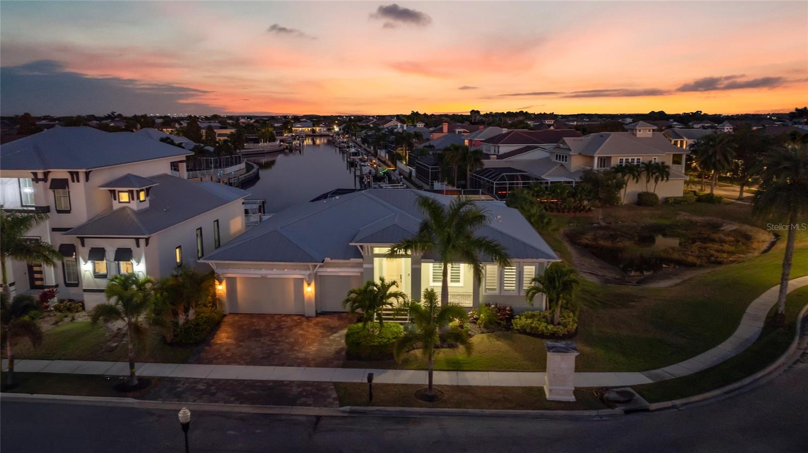 This home was built in 2023 but it lives as if it was brand new because the owners barely spent any time here, they are looking to get rid of their Florida waterfront stunner. Experience Resort-Style Living All Year in This Waterfront MiraBay Masterpiece. Discover unparalleled luxury and coastal charm in this stunning waterfront residence, perfectly situated within the highly coveted gated community of MiraBay. Blending elegance, comfort, and practicality, this exceptional home delivers the ultimate Florida lifestyle—complete with direct saltwater canal access just minutes from Tampa Bay. A boater’s paradise, the property features a private dock and boat lift, ideal for spontaneous sunset cruises or weekend adventures on the water. Step outside to your own private oasis—a custom-designed heated saltwater pool and spa accented with LED lighting and surrounded by a seamless panoramic screen enclosure that offers unobstructed water views while keeping even the smallest insects out. The expansive lanai is built for entertaining, complete with a gourmet outdoor kitchen featuring durable cabinetry, striking granite countertops, a full suite of outdoor appliances, and a Japanese teppanyaki grill—perfect for unforgettable culinary moments. A built-in kegerator with a custom dual-tap ceramic beer tower adds a playful, functional touch to this entertainer’s haven. Inside, the home showcases 4 spacious bedrooms, 3 full bathrooms, and a dedicated office with built-in cabinetry—ideal for remote work or quiet study. The open-concept kitchen serves as the heart of the home, boasting a waterfall-edge quartz island, under mount sink, and premium stainless steel appliances. Luxurious marble flooring flows throughout, complemented by soaring multi-tray ceilings with LED accent lighting for a dramatic yet inviting ambiance. The impressive pavered front porch and grand entryway set the tone for what’s inside. Retreat to the serene primary suite, where sliding glass doors open to the lanai and tranquil canal views. Remote-controlled blackout drapery ensures restful privacy, while the spa-inspired en-suite bath showcases elegant finishes and thoughtful details. Every bathroom is equipped with modern, high-end toilets featuring electric bidets. Additional upgrades include a whole-home generator, Culligan water treatment system, full irrigation, and a three-car garage with ample storage. You’ll also enjoy enhanced privacy. Smart home technology offers effortless control over pool settings, lighting, and more—making everyday living seamless. For those seeking a turnkey experience, high-end furnishings that have been barely lived in are also available for purchase, allowing you to move right in and embrace the MiraBay lifestyle.
As a MiraBay resident, you’ll have access to world-class amenities, including a state-of-the-art fitness center, luxurious clubhouse, tennis and pickleball courts, resort-style pools with waterslides, and an on-site café. Complimentary kayaks, paddleboards, and watercraft are also available for exploring the scenic canals and bay. This home isn’t just a residence—it’s a waterfront sanctuary offering an unmatched blend of sophistication and coastal living. Don’t miss this rare opportunity to own a piece of paradise in one of Apollo Beach’s most coveted communities. Schedule your private tour today and discover why MiraBay is the ultimate destination for refined Florida living.