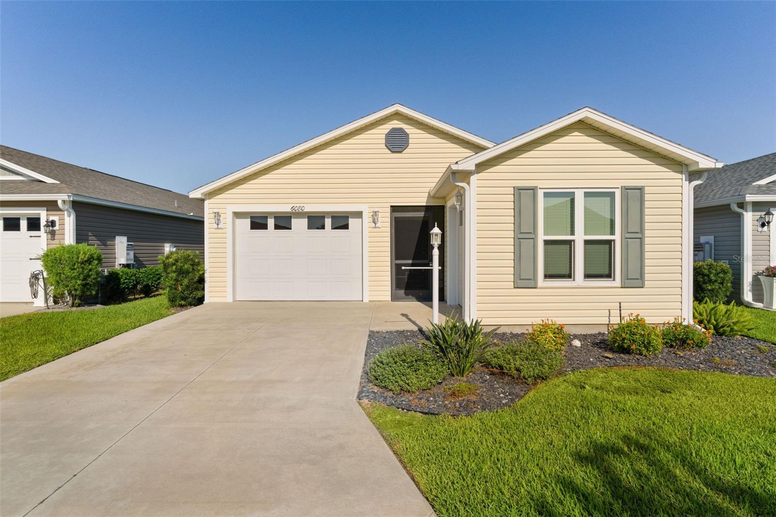 ~2019 ROOF, HVAC and HOT WATER HEATER~ ~TURNKEY~ ~10x10 SEPARATE GOLF CART GARAGE~ ~MID-CENTURY MODERN VIBE~
Welcome to this beautifully maintained TURNKEY EMERALD Patio Villa in the highly desirable Village of MONARCH GROVE, offering stylish finishes, low-maintenance living, and everything you need to start enjoying The Villages lifestyle right away! Step inside to discover an open and inviting floor plan with LUXURY VINYL flooring throughout the main living areas and VAULTED ceilings that enhance the spacious feel. The bright living room features a ceiling fan and flows seamlessly into the kitchen and dining area, creating the perfect layout for everyday living and entertaining. The kitchen offers attractive high-definition countertops, STAINLESS STEEL appliances, and a GAS stove, ideal for those who love to cook. Ample cabinetry and workspace make meal prep both easy and enjoyable. The private primary suite serves as a comfortable retreat with carpet flooring, vaulted ceilings, ceiling fan, and a spacious WALK-IN closet. The ensuite bath features a WALK-IN shower, linen closet, and high-definition countertops. The secondary bedroom offers carpet, a ceiling fan, and built-in closet, making it perfect for guests or a home office. The guest bath includes a shower/tub combination and matching high-definition countertops. Step outside to the screened lanai with ceiling fan, an ideal spot to relax with morning coffee or unwind in the evening while enjoying Florida’s beautiful weather. The home features a 1-car garage plus a 10x10 GOLF CART GARAGE, providing plenty of room for storage, your golf cart, and all your Florida lifestyle essentials. Whether you’re seeking a seasonal getaway, investment opportunity, or full-time residence, this turnkey Monarch Grove villa delivers comfort, convenience, and effortless living near Riverbend Rec Center, Southern Oaks Championship Golf Course, Edna's, Loblolly, Longleaf and Lowlands Executive Golf Courses, Sawgrass Grove, and Everglades Regional Rec Center. You are not far from Eastport as well. Seller scheduled painting of home so that walls will be neutral colors in August.