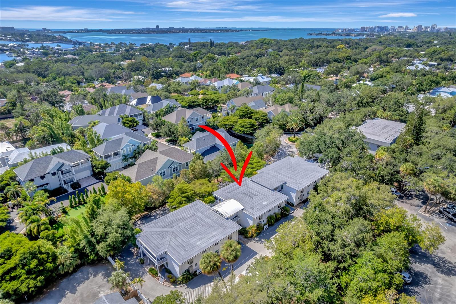 BACK ON THE MARKET!!! Buyer financing fell through. Location, Location, Location! Come see this rarely available hidden gem of a 1-bedroom, 1-bathroom, 2nd floor condo West of the Trail, nestled in a private street in the highly sought after Granada neighborhood only steps away to the Siesta Key North Bridge. 
This 12-unit quiet Condo Community is in a prime Sarasota location walking distance to Shops at Siesta Row including Publix, CVS, Cinebistro movie theatre, a variety of restaurants, stores and fitness studios, conveniently close to Siesta Key, Downtown, Marina Jack, Sarasota Memorial Hospital, Southside Village, Trader Joe's, Red Rock Park and top-rated schools. Whether you are looking for a permanent residence, investment property or vacation retreat, this condo is waiting for you to make it your own! Upon entering you’ll be greeted by a bright open floor plan living room/dining room combo leading into the kitchen and porch area. Step through the sliding glass doors into your large screened-in lanai offering an additional 149 sq ft, to relax sipping a cup coffee on a serene privacy setting with lush matures trees for a backdrop or to enjoy beautiful sunsets in the evening. This unit also features a spacious large bedroom with walk-in closet, plenty of storage space with three additional closets in the hallway leading to the newly painted bathroom, plus a covered carport spot right out back. Recent updates include Electric Panel (2022), Roof (2019), AC (2019), Tankless Water Heater (2016), all buildings Railings (2023). Don't miss the opportunity to own this charming condo maintained with love in a fabulous location! Schedule your showing today!