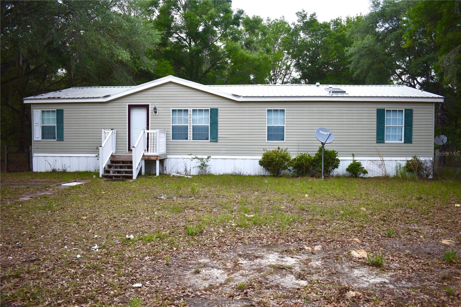 Welcome to peaceful country living in Bronson! This well-maintained 3-bedroom, 2-bath manufactured home sits on a spacious 1.25-acre lot, offering the perfect blend of privacy, comfort, and room to grow—with no HOA. Step inside to find a home that has been thoughtfully cared for over the years, with a functional layout ideal for everyday living. Major upgrades—including a newer metal roof and updated drain field—provide peace of mind and added value for the next owner. Outside, enjoy wide-open space with endless possibilities—whether you’re dreaming of a garden, outdoor entertaining area, or simply soaking in the quiet surroundings. With plenty of room for pets, toys, or even future additions, this property offers the flexibility that’s hard to find. If you’re looking for affordable acreage without sacrificing condition or convenience, this is one you don’t want to miss!