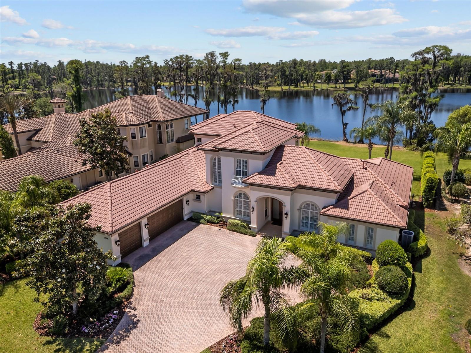 A rare opportunity to own a custom home on one of the premier lake front lots on Lake Merry Water in the gated community of Ladera. This 5-bedroom, 4.5 bath home with two large offices, bonus room, extended lanai, heated pool and spa and 3 car garage is just minutes to everything. Easy access to Tampa, the airport, schools/USF, hospitals, shopping and restaurants, yet far enough away that all you hear, feel and see is the quiet tranquility of living on a beautiful lake with park-like settings in a gated community. Inviting and open home with gorgeous views of Lake Merry Water from nearly every location in the home. Lake Merry Water is a bird watchers paradise with a community dock and only electric motors allowed. Oversized paver driveway for entertaining. 2 downstairs bedroom/bath suites equipped with walk in showers and large closets. First floor master bedroom, with spacious master bath and oversized dual-head shower. Custom California Closets build out completes the large walk in master closet. Gourmet Kitchen with 42" cabinetry, updated appliances with drop in 6 burner gas range and designer hood. Kitchen opens to large family room surrounded by views of the pool area and lake. Updated lighting fixtures and window shutters throughout. 2nd floor with huge bonus area, 2 bedrooms with window seats, 1 full bath and a spacious balcony for evening sunsets and moonlit nights looking out over the water. Zoned for Steinbrenner High, Buchanan Middle and Lutz K-8.