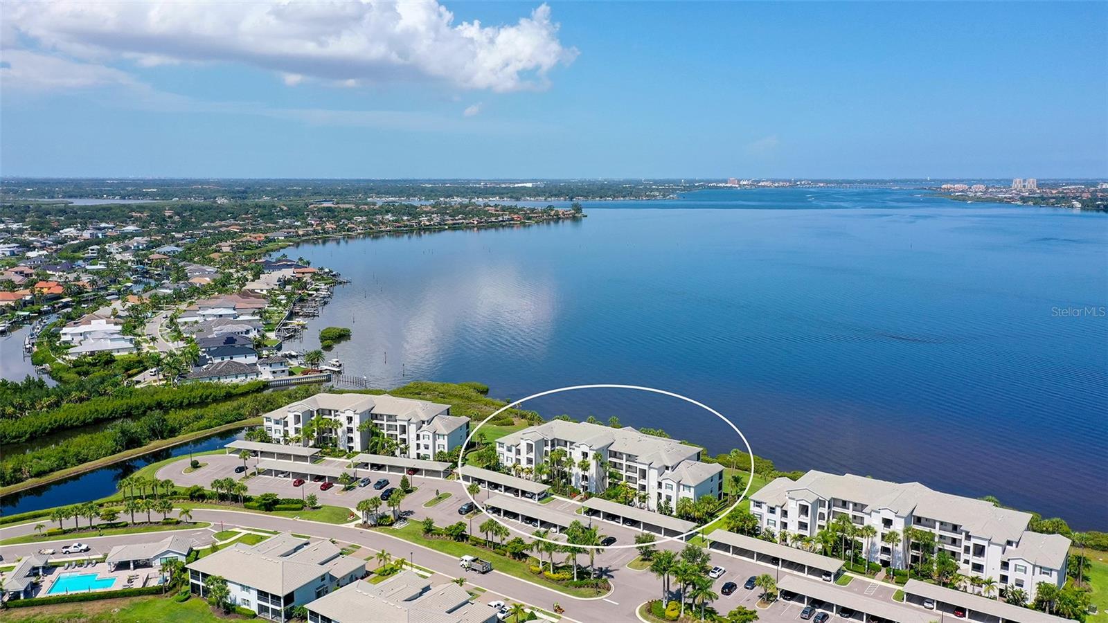 Seeking SUNSETS and Full RIVER VIEWS and a marina with boat docks and lifts? This stunning 1st floor condo offers the convenience of a first-floor walk-out with gorgeous river views. Located in 24/7 Manned Gate guarded Tidewater Preserve, these are maintenance free condominiums built in 2019! This particular model, the Birkdale, was the preferred floor plan, and it has been lovingly upgraded by the owners. Live life in this wonderful 2-bedroom, 2-bathroom condo which has phenomenal FULL River VIEWS from the entire living area and kitchen. Pet lovers will enjoy the lanai screened door for convenience and the fact that this is a pet friendly community that has its own dog park. Bonus, the new owner will have an assigned covered Carport and storage unit directly outside for bikes, golf clubs, etc. Tidewater Preserve is a lifestyle, and this particular unit is across the street from the satellite pool and fitness center. The unit itself was just freshly painted, and features... crown molding, tile floors on the diagonal, with upgraded flooring in the bedrooms, Ring doorbell system, coded entry, Honeywell smart thermostat can be connected to Alexa to lock doors remotely and turn down thermostat. The kitchen has Quartz counter tops along with a large island also made of quartz, stylish backsplash,  stainless-steel appliances, and a great breakfast bar area for additional seating, along with pendant lighting. Your clients will love the Open floor plan. The primary bedroom has a walk-in closet, and the ensuite has a wonderful shower, and quartz countertops. The laundry room is located in its own space in the hallway. Tidewater Preserve is conveniently located near I75, its main pool rivals top resorts with River views and an outdoor grill and fireplace. The Clubhouse has been remodeled with a nice community kitchen, new flooring, and hosts many events, and the main pool overlooks the river. They have two 24/7 fitness centers, two satellite pools, Marina with a 2nd Clubhouse, tennis courts, kayak and canoe launch, walking trail for scenic strolling. The Marina has boat slips that you can rent monthly through the activity manager! Come see what all the fuss is about and leave the concrete jungles up North! I have been involved in this community since day one and also own a unit in the complex. I can tell you this, in my opinion, this is one of the best views of all the ground floor units Agent can show easily, so call me!