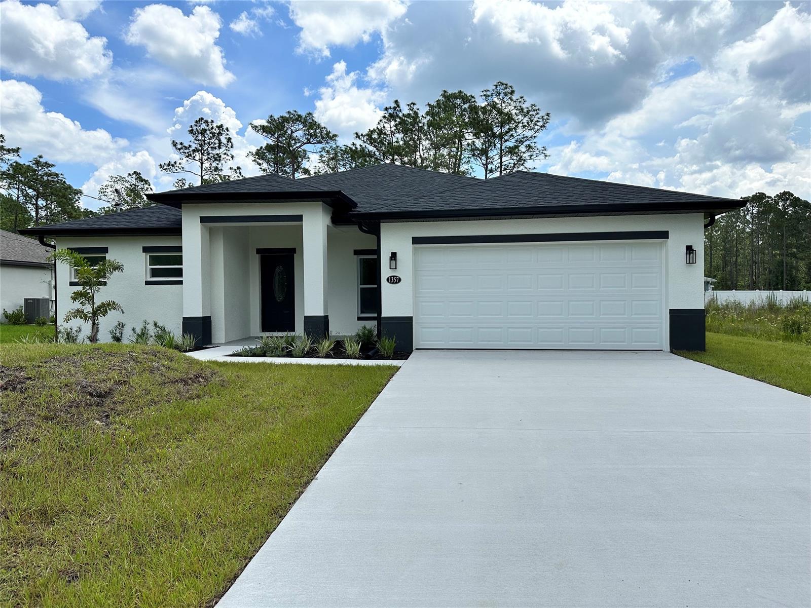 No HOA! The home will provide a nice laid out floor plan that is fully functional featuring a beautiful kitchen that will overlook the spacious living room and dining room, as well as the covered lanai and large backyard. The primary bedroom and en-suite bathroom are completely on one side of the home while the other bedrooms and baths are on the opposite end. You will enjoy the designer touches thoughtfully added throughout the home. The amazing kitchen boasts solid wood Espresso shaker cabinets with brushed nickel handles, Quartz countertops with a waterfall designed island and wrap around cabinets, Stainless Steel Appliances, matte pendants lights and matching spring spout faucet, LED recessed lighting and closet pantry with built-in shelves. The entire home has waterproof luxury vinyl plank flooring, 5 1/4” baseboards, and built-in shelving in all of the closets. Bathrooms are have plenty of upgrades with custom decor tile, vanity faucets, mirrors and lighting...not to mention the relaxing spa shower feature in the primary bathroom. The property is so grand, you can choose to sit on your front porch to view the lovely landscaped front yard and oversized driveway...or snuggle up on the lanai and enjoy the quiet comforts of your own backyard. You will appreciate the additional efficient features such as the Hybrid Smart Tank Water Heater, Dual Pane Double Hung Windows, Rain Gutters and Pebble Tech painted garage and porch floors. Enjoy Florida living in this convenient location with all of the rich History, Art and Adventure that DeLand has to offer. Just minutes from and easy access to major shopping, dining and entertainment, Downtown DeLand’s Historic Garden District, De Leon Springs State Park, Stetson University, Advent Health DeLand, DeLand Municipal Airport, US 92, I-4, Embry Riddle Aeronautical University, Daytona Beach and New Smyrna Beach.