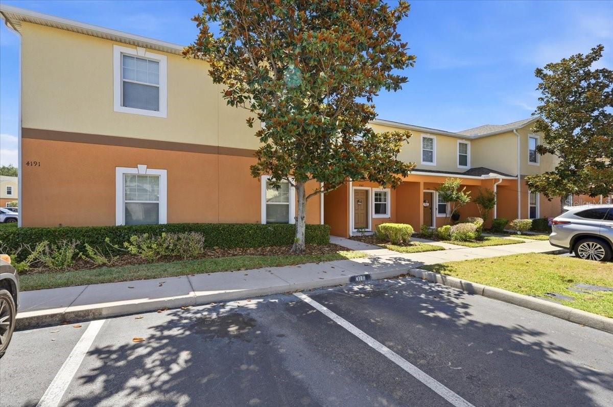 Welcome to 4187 Shade Tree Lane of south Lakeland where stylish updates, comfortable living, and everyday convenience come together in the gated community of Autumnwood Grove. This beautifully maintained 2-bedroom, 2.5-bath townhome offers 1,224 square feet of thoughtfully designed living space with tasteful upgrades, low-maintenance living, and an ideal location just a short walk from the community pool and mailboxes. Step inside to discover a bright, inviting interior enhanced with modern designer accent walls that add warmth and character throughout the home. The spacious two-story floor plan features luxury vinyl plank flooring throughout the upstairs and bedrooms, installed in 2022, along with freshly replaced stair carpeting. Tile flooring in the entryway, kitchen, and bathrooms offers durability and easy maintenance. The first floor offers a comfortable living area, a convenient half bath for guests, and a functional kitchen with updated appliances, including a newer refrigerator. Sliding glass doors lead to a screened patio, creating the perfect space to enjoy your morning coffee, grill with friends, or simply relax outdoors. An attached exterior storage closet provides additional room for seasonal items and everyday essentials. Upstairs, both bedrooms offer exceptional storage with two closets in each room. The primary suite features a private en-suite bathroom, while the second bedroom is served by its own full bath nearby, making the layout ideal for guests, roommates, or a home office. The newer Whirlpool washer and dryer, installed in 2025, are also included with the home, offering added value for the next owner. Additional improvements include an upgraded A/C system with a UV light designed to help improve indoor air quality. The home includes one assigned, uncovered parking space along with abundant guest parking nearby, an added convenience thanks to its desirable location close to the community pool. Exterior maintenance is included through the HOA, allowing you to spend less time on upkeep and more time enjoying everything this community has to offer. Conveniently located just minutes from the Polk Parkway for an easy commute throughout Central Florida, this home is also close to Highland City Publix, RaceTrac, Polk State College, shopping, dining, medical facilities, and other everyday conveniences. FHA and VA eligible, 4187 Shade Tree Lane presents an outstanding opportunity to own a move-in-ready home in one of South Lakeland's desirable gated communities.