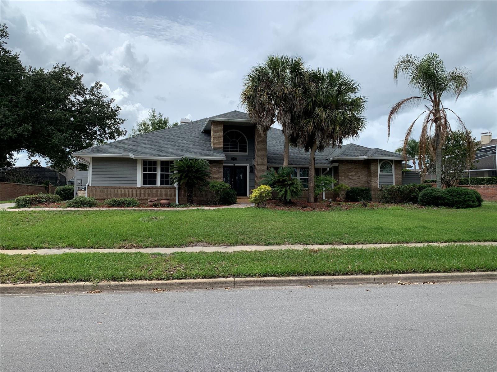 Looking for lots of lawn space in a golf club community home?  Look no further than this beautiful home at 434 Silver Dew in the golf course community of Timacuan.  You have to see the back yard that's entirely surrounded by a brick wall giving you loads of space and privacy for family and pets.  With 4 bedrooms & 3 and 1/2 bath rooms the home has all the amenities you expect in an executive home such as this.
Built as a split plan, the primary bed and bath are to once side of the home and the other bedrooms and baths are to the opposite side of the home.  In the center is the where it all comes together featuring a formal living and dining area as well as a family room with wet bar and wine fridge and an eat in kitchen that looks out over the pool and onto to the expansive yard.  The large covered Pool side lanai also has a wet bar sink, a sauna, and a hot tube rounding out the complement of items for relaxing and enjoying time by the pool.  Two of the bath rooms have been recently remodeled as has part of the pool tile and Kitchen backsplash.   One of the more unique features in this home is the Laundry room that's been made to be a small kitchenette or prep kitchen if you have others in the household who would like to have there own space to cook and clean.  If you're looking for a home with flexibility to accommodate young and old alike this home needs to be on your list of homes to see.