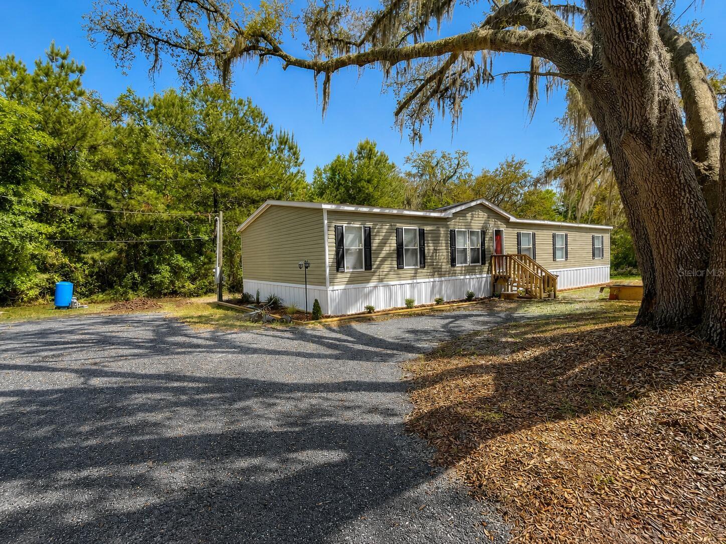 Welcome to this beautifully updated 5BR/3BA home in Lake City, FL. Step inside you’ll find fresh paint, upgraded crown molding and baseboard, and all new waterproof LVP flooring throughout. The open living area connects to a bright kitchen featuring new refrigerator, range oven, and range hood. All five bedrooms and two living rooms provide generous space — great for families, guests, or home office setup. The oversized primary suite boasts a large walk-in closet and a relaxing garden-tub bathroom. Step outside to enjoy a newly built deck with stairs, great for outdoor dining or weekend grilling. A new driveway with ample parking adds everyday comfort. Located just minutes from US-90, I-75 and I-10 for easy access to shopping, dining, and schools. Washer and dryer are included. Some photos have been virtually rendered.