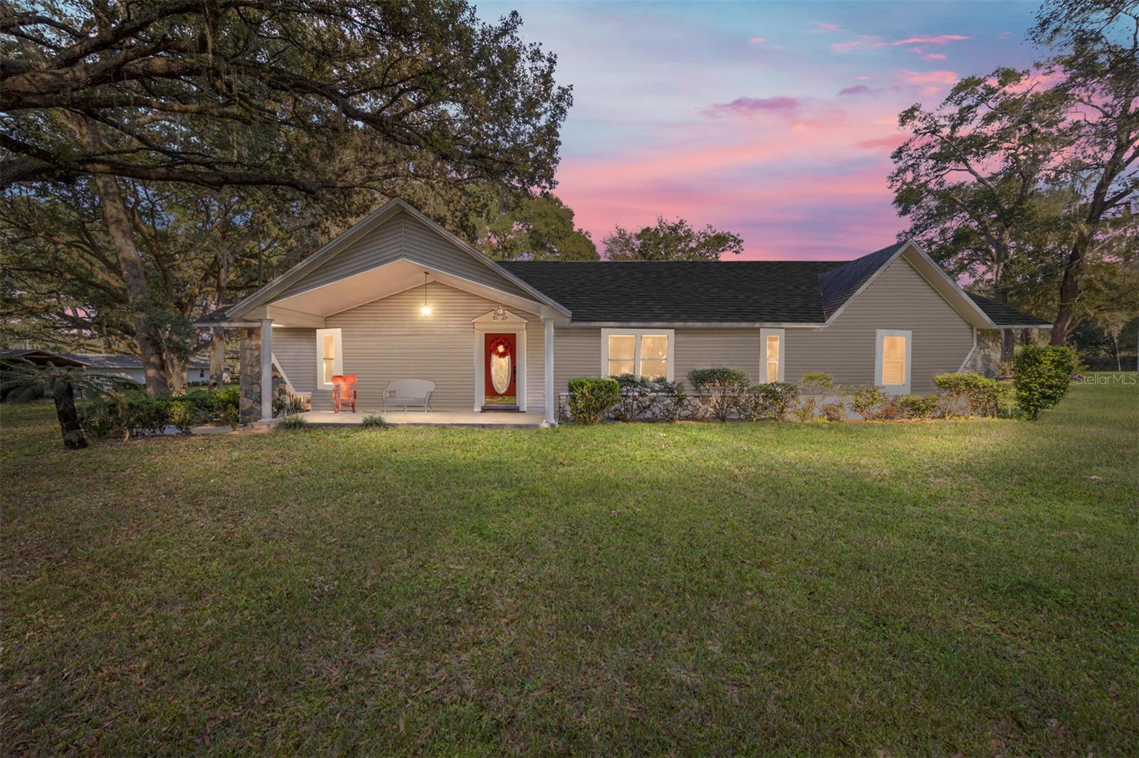 This property is truly a dream for those seeking space, versatility, privacy, and the peace of country living. Set on nearly 5 fully fenced acres off a paved road, the property welcomes you through electric gates and a winding drive lined with gorgeous scattered oak trees, leading to a large parking area and convenient carport access to the main home.

Offering over 2,600 square feet of living space, the main residence features 3 bedrooms and 2.5 bathrooms with plenty of room for comfortable everyday living and entertaining. The screened-in inground pool and spa create an inviting outdoor retreat, while the surrounding acreage provides excellent privacy from neighboring properties. Gardening enthusiasts will love the raised vegetable beds and greenhouse, offering wonderful opportunities for year-round enjoyment.

In addition to the main home, a separate 1-bedroom, 1-bath apartment with its own private entrance provides excellent flexibility for guests, extended family, rental income, or caretaker quarters. The garage/workshop is a true dream for anyone needing space to work, store equipment, pursue hobbies, or operate a home-based business. Additional features include boat storage, RV hookups, and two RV carports with 30- and 50-amp plug-ins for RVs, trailers, or outdoor toys.

With zoning that supports horses and livestock, this property is ideal for equestrian enthusiasts or anyone seeking a versatile country lifestyle. Enjoy the quiet and privacy of the countryside while remaining conveniently located just 20 minutes from both Ocala and Gainesville.
