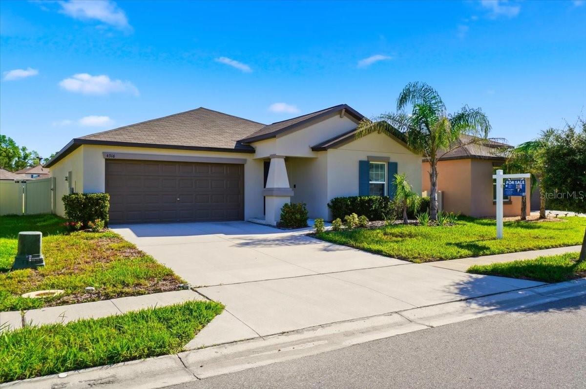 Curb appeal meets modern comfort in this nearly-new 2023 home! A charming covered entry with navy shutters and tropical landscaping welcomes you inside, where an open-concept layout flows seamlessly with tile flooring throughout. The kitchen shines with granite counters, a tiled backsplash, stainless steel appliances, and a spacious island overlooking the combined living/dining area — perfect for entertaining. Central heat/air keeps things comfortable year-round, while ceiling fans in every bedroom and the main living space add everyday comfort. The master suite offers a walk-in closet, linen closet, dual-sink vanity, and walk-in shower. A separate laundry room with full-size washer/dryer and a 2-car garage round out the interior, while the fully fenced backyard with a pond view offers privacy and relaxation. Enjoy community amenities including a pool and dog park, all for a low $216/year HOA. Buyers can move in with added peace of mind thanks to the Lennar Limited Warranty covering structural components. Just off I-4 — about 45 minutes to Tampa, 50 minutes to Orlando — and close to LEGOLAND, Camp Margaritaville RV Resort & Cabana Cabins, Lakeland Airport, and Sun 'n Fun. Schedule your showing today!