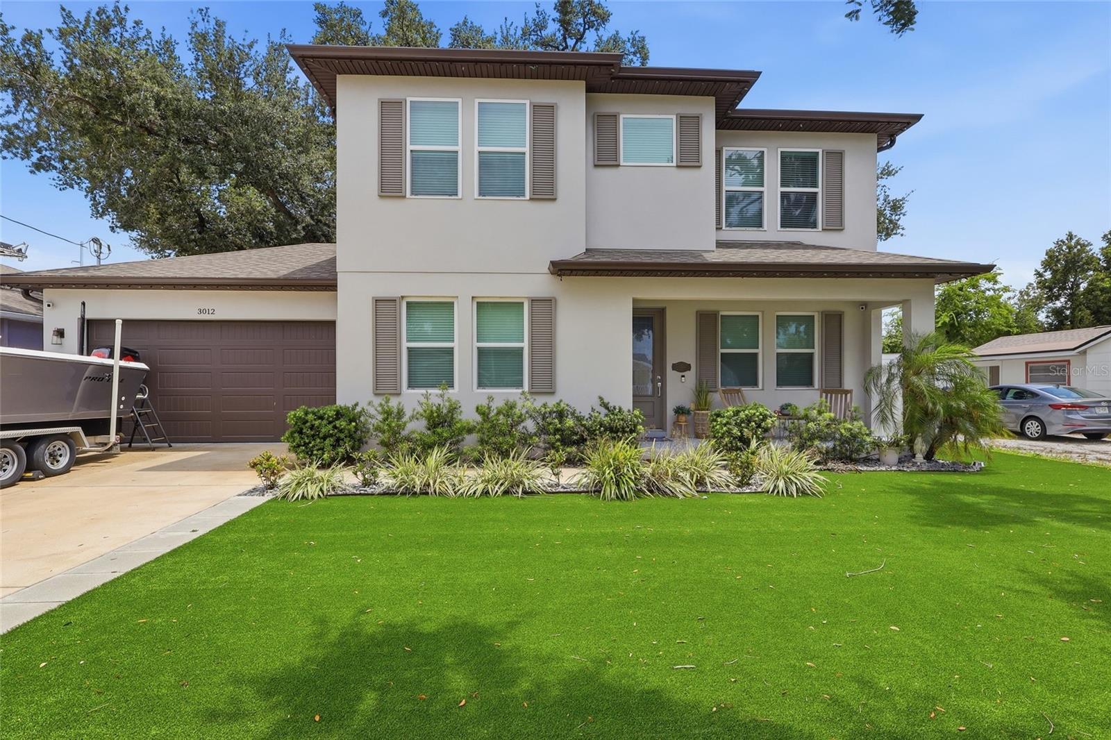 Built in 2020, this stunning custom residence combines modern luxury, energy efficiency, and exceptional craftsmanship in one of Tampa's most convenient locations. Constructed with durable concrete block construction and situated outside of a flood zone, this meticulously maintained home offers peace of mind and lasting value.

Step inside to discover soaring 10-foot ceilings adorned with elegant crown molding, creating a bright and luxurious atmosphere throughout. The chef-inspired kitchen serves as the heart of the home, featuring 42-inch soft-close cabinetry, luxurious granite countertops, stainless steel appliances, and a spacious walk-in pantry designed for both functionality and style.

The thoughtfully designed floor plan includes a luxurious primary suite complete with a custom-built walk-in closet. Hurricane-impact windows provide enhanced storm protection, security, and energy efficiency, while dual HVAC systems—one dedicated to each floor—maximize comfort and efficiency year-round.

Outdoor living is equally impressive with premium artificial turf installed in both the front and backyard, delivering exceptional curb appeal with minimal maintenance. Entertain with ease in the newly added outdoor kitchen, perfect for hosting family and friends. Additional highlights include a generator hookup, a spacious two-car garage, and quality finishes throughout.

Ideally located just minutes from Tampa International Airport, Raymond James Stadium, International Plaza and Bay Street, and Midtown Tampa, this home has unparalleled access to shopping, dining, entertainment, and major commuter routes. Enjoy a short drive to Downtown Tampa, Armature Works, and the vibrant Tampa Riverwalk, making it easy to experience everything Tampa Bay has to showcase.

This exceptional property delivers the perfect combination of modern luxury, thoughtful upgrades, and prime location. Virtual Video Tour Available. Book your Private Tour Today!