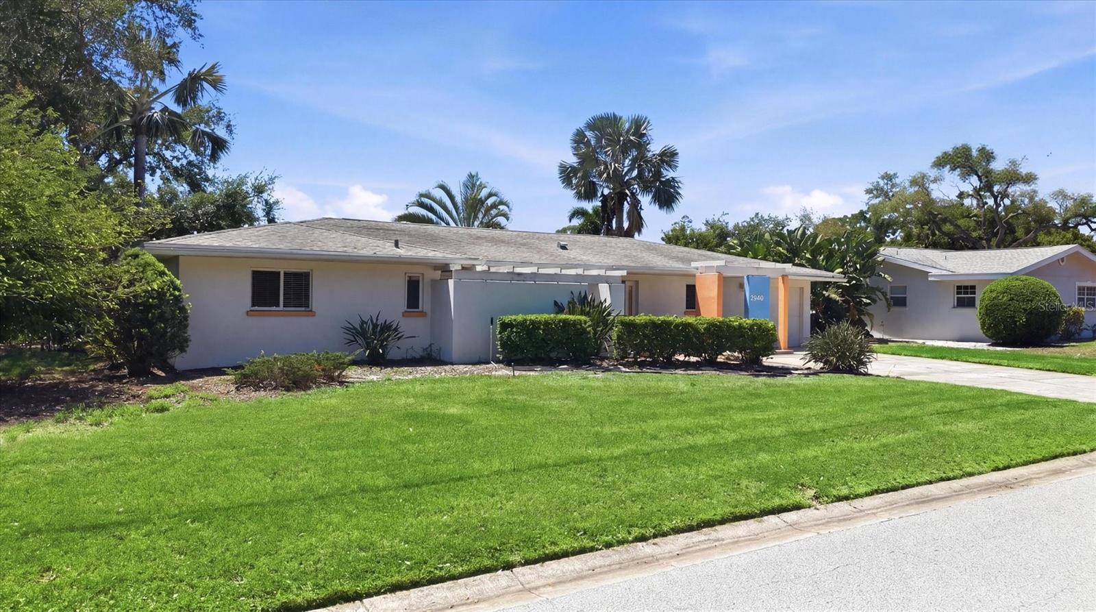 Stunning, mid-century  modern home in highly desirable South Gate with views you must see to believe! If you could have picked one of the best lots in South Gate back in the 1960’s this may have been it. The two-bedroom plus office, two bath home sits on a bluff overlooking a wide portion of Philippi Creek including a large aquatic preserve. You’ll be mesmerized by long, unobstructed views in every direction. A nature lovers delight and absolutely intoxicating. But while location is important, there are many more features in this  classic home to consider. Entering through the large foyer you’ll immediately notice beautiful terrazzo floors throughout and a great room with vaulted ceilings. There’s an adjacent dining area off the kitchen and all of these spaces look out through what appears to be a “wall of glass” dedicated to the world class view of flora and fauna. The primary bedroom also has views and access to the back yard and the primary bathroom has been upgraded with a separate tub and walk in shower. The den/office can be made more private with sliding pocket doors and function as a guest bedroom. It even has a dedicated, enclosed patio and garden space. There’s an attached, oversized garage with room for your workshop and a double wide driveway with plenty of parking. While this home has been appropriately updated and improved over the years you’ll find it’s all been done with a great sensibility to the original intent, quality and “hipness” so many are learning to appreciate, again.
