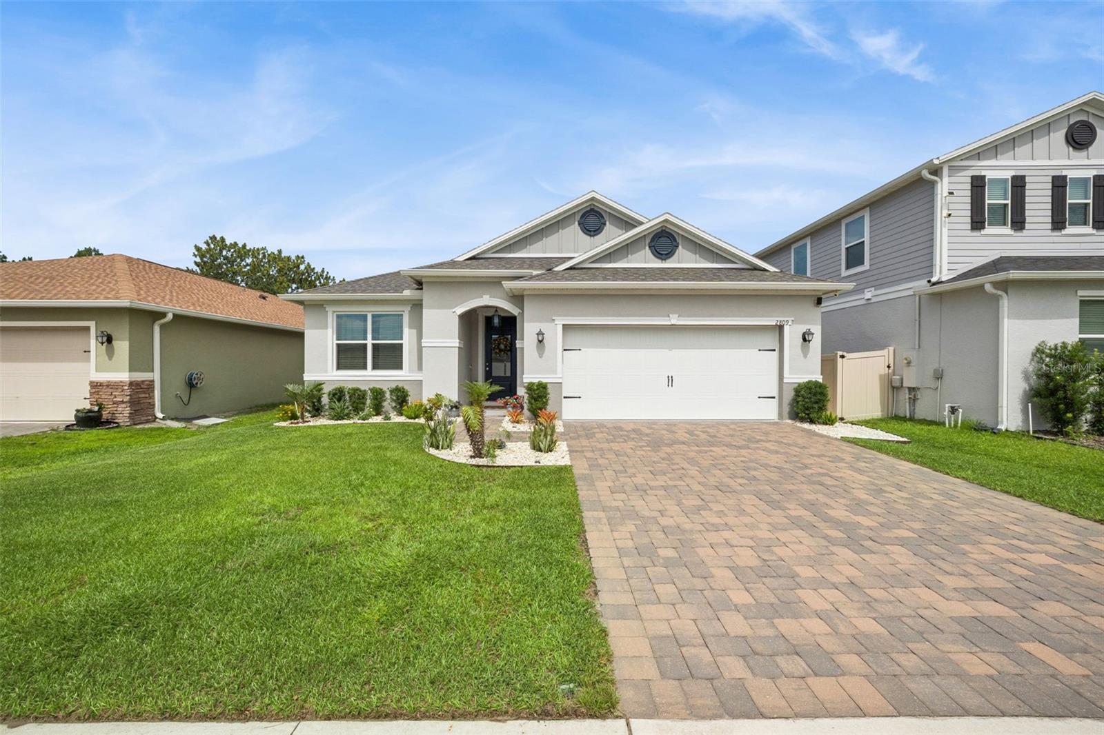 Welcome to your own private retreat! Located in the highly desirable community of Sanctuary, this property has the peaceful nature views, modern comfort, and an exceptional location you've been looking for. This stunning single story home includes 4 bedrooms, 3 bathrooms, and a thoughtfully designed layout that makes everyday living and entertaining effortless. From the moment you arrive, the spacious paver driveway and covered front entry create a warm and inviting first impression. Step inside to discover soaring ceilings, beautiful wood-look tile flooring, and an expansive hallway that sets the tone for the rest of the home. Natural light fills the interior, creating a bright and welcoming atmosphere throughout. The home's thoughtfully designed floor plan provides plenty of space for everyone! Additional bedrooms are positioned near the front, with each offering generous storage, plenty of space, and abundant natural light for family members or guests to feel right at home, or as your own dedicated home office space. At the heart of the home, the open-concept living spaces were designed for connection and convenience. The kitchen seamlessly overlooks the living and dining areas, ensuring you're always part of the conversation whether preparing meals or hosting gatherings. Featuring a large center island with breakfast bar seating, stainless steel appliances, a beautiful subway tile backsplash, a spacious closet pantry, abundant recessed lighting, and extensive counter space, this kitchen is as functional as it is stylish so any sized meal will feel effortless. The spacious living room creates a comfortable place to gather, unwind, and make lasting memories with loved ones and the adjacent dinette area provides the perfect setting for everyday meals while offering relaxing views of the backyard. Tucked away for privacy, the primary suite serves as a luxurious retreat. The spacious bedroom offers a peaceful escape, complemented by a large walk-in closet and luxurious en suite bathroom. Dual sinks provide convenience for busy mornings, while the oversized walk-in shower offers the perfect place to relax and recharge after a long day. Step outside and discover one of the property's most impressive features! The screened lanai allows you to enjoy Florida's beautiful weather year-round while taking in views of the nature preserve behind the home. With no rear neighbors, you'll enjoy an added sense of privacy and tranquility that is becoming increasingly difficult to find. The fully fenced backyard provides plenty of room for four legged friends, play, gardening, or simply enjoying the peaceful surroundings. Life in Sanctuary extends beyond your front door. Residents enjoy access to resort-style amenities including a sparkling community pool, as well as a splash pad, playground and a new well-equipped fitness center, providing opportunities for recreation and relaxation just moments from home. Conveniently located off of Highway 27, you'll enjoy quick access to Walt Disney World, Champions Gate's renowned golf courses, shopping, dining, and entertainment destinations. Everyday conveniences, excellent schools, grocery stores, and outdoor adventures at nearby parks such as Lake Louisa State Park are all within easy reach. With privacy, scenic views, and an outstanding location, this beautiful home presents an incredible opportunity to enjoy the very best of Central Florida living. Don't miss out, schedule your private showing TODAY!