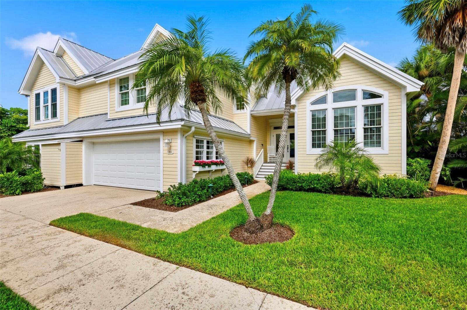 Located in one of Boca Bay’s most desirable waterfront settings within the North Village neighborhood, this rare “Buttonwood” residence enjoys a timeless backdrop of glistening waters, an iconic Old Florida gazebo, and a stately century-old banyan tree. One of only three homes of its plan in the neighborhood, the residence offers just over 2,000 square feet of refined living space, including two bedrooms, a generous bonus room, and two-and-one-half bathrooms.
Recent improvements add both quality and peace of mind, including a 2023 standing seam metal roof, electric roll-down shutters for door openings, and a motorized stair lift from the 2-car garage to the main living level. The interiors feature refinished oak flooring throughout the primary living spaces, centered around a completely remodeled kitchen with gas range, double wall ovens, updated cabinetry, and stone counters. The primary bathroom and powder room have also been thoughtfully updated, blending comfort with refined coastal design. An expanded waterside screened lanai extends the living area outdoors, featuring a dedicated bump-out for a gas grill with integrated gas line—ideal for relaxed waterfront dining and entertaining.
Ideally positioned, the home offers quick access to Boca Bay’s exceptional amenities—including the nearby Boca Bay Beach Club, multiple pools, North Village tennis and pickleball courts, community boat docks, and all of the offerings at the Pass Club, with its dining, fitness center, and Har-Tru tennis complex. Direct Gulf beach access is also just a short walk away, along with easy proximity to Boca Grande’s historic village and shops.
A rare opportunity to enjoy one of Boca Bay’s most charming and classically beautiful waterfront settings.