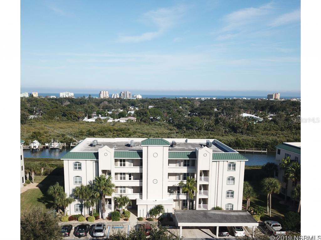 Enjoy all the amenities Bouchelle Island and New Smyrna Beach have to offer from your water view condo in quiet solid concrete building. 1681 sq. ft of living space. One of the largest 2/2 condos with additional flex space for family room or study. Freshly painted, newer kitchen and ready for immediate occupancy. Enjoy the morning sunrise from your waterfront screen enclosed porch. 
Large open floor plan, corian kitchen counter tops, spacious master bedroom with large ensuite bath complete with double sinks, garden tub and walk in shower as well as vanity area and walk in closets. This Central location is between the beach and downtown shopping on canal Street. Easy bike path to all locations east and west of Bouchelle Island, Amenities include a boardwalk, two pools (one custom), large pool decks each featuring an outdoor gas grill, a spa located at the main pool, two lighted tennis courts, shuffleboard courts, a fitness area, and a clubhouse which includes an organized library .

There is also an area where you  can wash your car located near the second common element area. The Association also maintains an 18-hole pitch & putt golf course 
Call now to schedule your tour as condos like these rarely are available. ;Security: Patrol