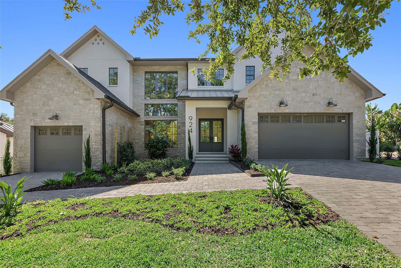 Ready For Move-In (Non-Flood Zone and Non-Evacuation Zone)! Explore your newly constructed luxury home in the highly coveted Allendale neighborhood. Designed by luxury builder JBrowning Designs, this exquisite home features solid block construction (first and second floors) and is situated over 35 feet above sea level, ensuring unmatched durability and peace of mind across 4,268 air conditioned square feet. 

Upon entering through the grand double doors at 924 42nd Ave, you’ll discover a gourmet chef’s kitchen, five elegantly designed bedrooms, and four full bathrooms. The first-floor owner’s suite is an exceptional highlight, offering dual walk-in closets and an ensuite bathroom with a walk-in shower, soaking tub, and dual vanities for a spa-like retreat. A versatile additional bedroom on the first floor serves perfectly for family, guests, multi-generational living, or as a convenient home office with direct access to main living areas and outdoor spaces.

Custom woodwork, vaulted ceilings, and luxurious European oak flooring enhance the home's distinctive character. The expansive kitchen is a chef’s dream, featuring a walk-in pantry, a large island, and premium Thermador appliances, including a full-size wine refrigerator.

Step outside to enjoy the luxury of a heated pool with a spillover spa, situated within an expansive outdoor living area perfect for relaxation and entertaining. A covered lanai extends your enjoyment year-round, featuring a built-in BBQ grill and a poolside half bath.

Inside, ascend the stunning staircase to the second floor, where you’ll find three additional bedrooms, two full bathrooms, and a versatile flex space for use as a living room or study area. Conveniently, laundry rooms are located on both levels.

This luxury home is prewired for a smart home system, ready for Lutron lighting, wireless shades, audio systems, security cameras, and a full house generator. Safety and efficiency are prioritized with impact-rated ES windows and doors, a designer shingle roof with a metal entry, and state-of-the-art Trane HVAC systems. Experience energy efficiency with Rinnai tankless water heaters and spray foam insulation.

A spacious 3-car garage with 11-foot ceilings and high-lift doors accommodates your lifestyle needs. This extraordinary residence offers an unparalleled blend of luxury, comfort, and modern technology in the prestigious, tree-lined Allendale neighborhood. 20 Minutes to Tampa International Airport, 20 minutes to Award Winning Beaches, 7 minutes to waterfront downtown St. Petersburg.