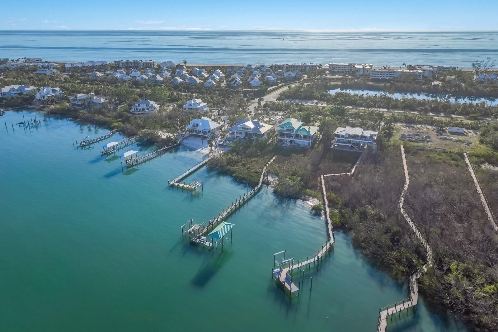 The perfect waterfront family retreat with room for everyone! Privacy, quality engineering, and craftmanship are the hallmarks of this 5,192 square foot custom built 6 bedroom and 6 bathroom home overlooking Gasparilla Sound. 6 Peekins Cove Drive is situated on 1.23 acres with boundless outdoor living space with room to add a swimming pool and cabana. The winding driveway offers several outdoor parking options as well as access to a 4 car garage and 3 stop elevator. The open floorplan kitchen and great room extends out to a large wrap around porch, all with stunning water views. The primary bedroom is also located on the main living level, offering direct water views, large walk-in closets and an ensuite bathroom with a jet bathtub. The southeast corner of the main level offers a spacious office or den, with an ensuite bath, or you could choose to use this space as a 7th bedroom. Hidden on the rear porch is a stainless-steel summer kitchen, great for grilling or even a fish fry. The second level features 5 bedrooms with 4 full bathrooms, a family room, laundry closet, and a screened outdoor porch. This level provides abundant space for family and friends, allowing the owner their privacy contained on the main level. The concrete block and poured slab foundation contains a 26’ x 40’ enclosed garage for cars, golf carts or even a boat. There is also an additional storage space measuring 19' x 31' adjacent to the oversized garage.There is a separate air conditioned mud room and exercise room on this level as well. To the east lays a small private beach to launch kayaks and paddle boards into the protected cove. The private dock leads to a covered 10,000 pound lift and a 24,000 pound lift, which are perfect for accessing the deep waters of Peekins Cove with direct access to both Charlotte Harbor and the Gulf of Mexico. This property is a must see for anyone looking to own a home perfectly suited to entertain a multigenerational family.