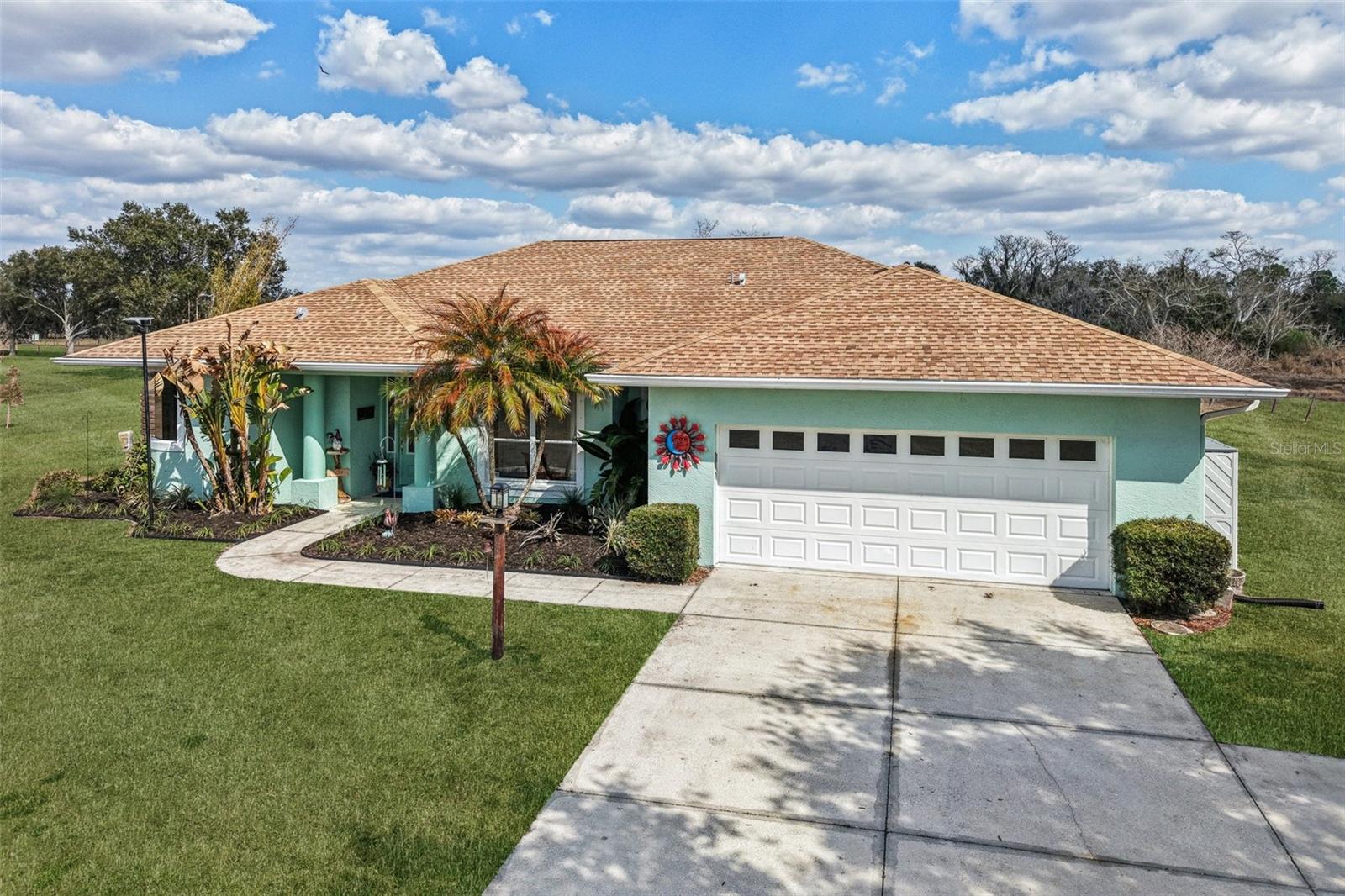 This is one of the best opportunities for usable acreage in the Sarasota area — ~5 acres with pool, room for barn/workshop, and rural zoning for animals - and only a short drive to Sarasota and white sandy beaches! Set within a rural community where neighbors keep horses, cows, goats and chickens, this well-maintained property offers practical acreage living with the space and flexibility many buyers are craving today. The land is open and usable, with an existing concrete pad already in place, ideal for a future barn, detached garage/workshop or guest house. Not heavily wooded, so fencing could be easily added to create defined areas for animals, gardening or additional structures as desired. Zoning (and HOA) allows for horses, livestock and outbuildings, giving the next owner the opportunity to tailor the property to their imagination. Inside, this bright and functional home offers 2,355 sq feet of comfortable living space, including 3 bedrooms in a split layout, plus a flex room suitable for an office, hobby space or nursery. There are 2 full baths and a half / cabana bath adjoining the second bedroom. The open plan kitchen with stainless appliances and two islands overlooks the pool and the large combined dining / living / family room - plenty of space to host a crowd. Outside, enjoy the pool and screened lanai, along with a smaller fenced area for pets or play. The surrounding area offers the natural beauty that draws many to rural Sarasota - frequent deer and sandhill crane sightings, open skies and peaceful nights under the stars. Located within an HOA community that supports rural living, the property offers a balance of space and neighborhood, and the area is known for it's laid-back, country feel while still being within a easy reach of town. Major improvements include new vinyl flooring throughout, water heater, and dishwasher (2025), pool resurface, lanai paving, exterior/interior paint and hurricane shutters (2023) and roof and A/C (2017). If you've been looking for usable acreage with flexibility and potential, this property is worth a closer look.