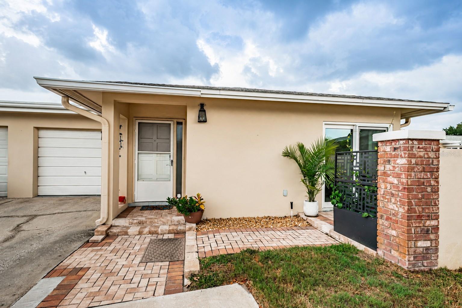 Welcome to carefree Florida living in the highly sought-after Highland Lakes 55+ community in Palm Harbor! This beautifully updated 1-bedroom, 1-bath home with a garage offers comfort, style, and an unbeatable location close to world-class beaches, premier shopping, dining, golf, and Tampa International Airport.

Step inside and discover a bright, inviting interior featuring luxury vinyl plank flooring throughout, wide baseboards, and double-pane hurricane-impact windows for peace of mind and energy efficiency. The spacious bedroom includes two walk-in closets, a ceiling fan, and direct access through a sliding glass door to a private outdoor patio retreat.

The updated kitchen is sure to impress with white shaker-style cabinetry, granite countertops, a stunning tile backsplash, stainless steel appliances, a pantry, and a reverse osmosis water filtration system. The open living area offers another sliding glass door leading to the outdoor sitting area, creating seamless indoor-outdoor living.

The beautifully renovated bathroom features a floor-to-ceiling tiled walk-in shower with a glass enclosure, an oversized vanity, and abundant storage space. Additional highlights include a dedicated laundry area with washer, dryer, and utility sink, ample storage throughout the home, AC and water heater less than 3 years old. 

Outside, enjoy your own private paved patio, perfect for morning coffee, evening cocktails, or simply relaxing in the Florida sunshine. Combining tasteful updates, exceptional storage, and a prime Palm Harbor location, this move-in-ready home is the perfect place to enjoy the active Highland Lakes lifestyle.