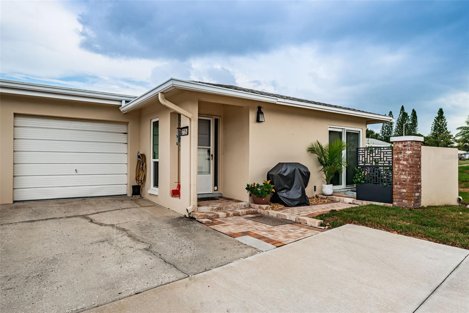 Welcome to carefree Florida living in the highly sought-after Highland Lakes 55+ community in Palm Harbor! This beautifully updated 1-bedroom, 1-bath home with a garage offers comfort, style, and an unbeatable location close to world-class beaches, premier shopping, dining, golf, and Tampa International Airport.

Step inside and discover a bright, inviting interior featuring luxury vinyl plank flooring throughout, wide baseboards, and double-pane hurricane-impact windows for peace of mind and energy efficiency. The spacious bedroom includes two walk-in closets, a ceiling fan, and direct access through a sliding glass door to a private outdoor patio retreat.

The updated kitchen is sure to impress with white shaker-style cabinetry, granite countertops, a stunning tile backsplash, stainless steel appliances, a pantry, and a reverse osmosis water filtration system. The open living area offers another sliding glass door leading to the outdoor sitting area, creating seamless indoor-outdoor living.

The beautifully renovated bathroom features a floor-to-ceiling tiled walk-in shower with a glass enclosure, an oversized vanity, and abundant storage space. Additional highlights include a dedicated laundry area with washer, dryer, and utility sink, ample storage throughout the home, AC and water heater less than 3 years old. 

Outside, enjoy your own private paved patio, perfect for morning coffee, evening cocktails, or simply relaxing in the Florida sunshine. Combining tasteful updates, exceptional storage, and a prime Palm Harbor location, this move-in-ready home is the perfect place to enjoy the active Highland Lakes lifestyle.
