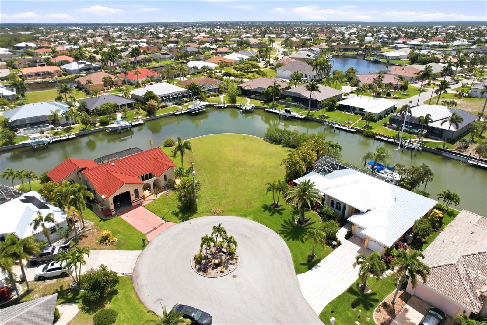 Exceptional oversized waterfront tip lot located in the highly desirable Punta Gorda Isles “Bird Section.” This rare 0.29-acre cul-de-sac parcel boasts an impressive 168 feet of city-maintained seawall, offering expansive intersecting canal views and multiple angles to design your custom coastal dream home. Positioned at the end of a quiet street, this premier tip lot provides enhanced privacy along with outstanding waterfront exposure. Enjoy quick sailboat access with no bridges—perfect for boating enthusiasts seeking effortless passage to Charlotte Harbor and the Gulf of Mexico. Public water and sewer are in place, simplifying the building process and adding long-term value. Surrounded by upscale waterfront homes, this property is ideally located just minutes from historic downtown Punta Gorda and Fishermen’s Village, where you’ll find waterfront dining, boutique shopping, art galleries, and year-round events. Nearby parks, walking and biking paths, fishing piers, golf courses, medical facilities, and everyday conveniences add to the appeal, while Punta Gorda Airport is easily accessible for regional travel. This is a rare opportunity to secure a premium tip lot in one of Punta Gorda Isles’ most sought-after waterfront communities—offering generous frontage, wide water views, and the ultimate Southwest Florida lifestyle.