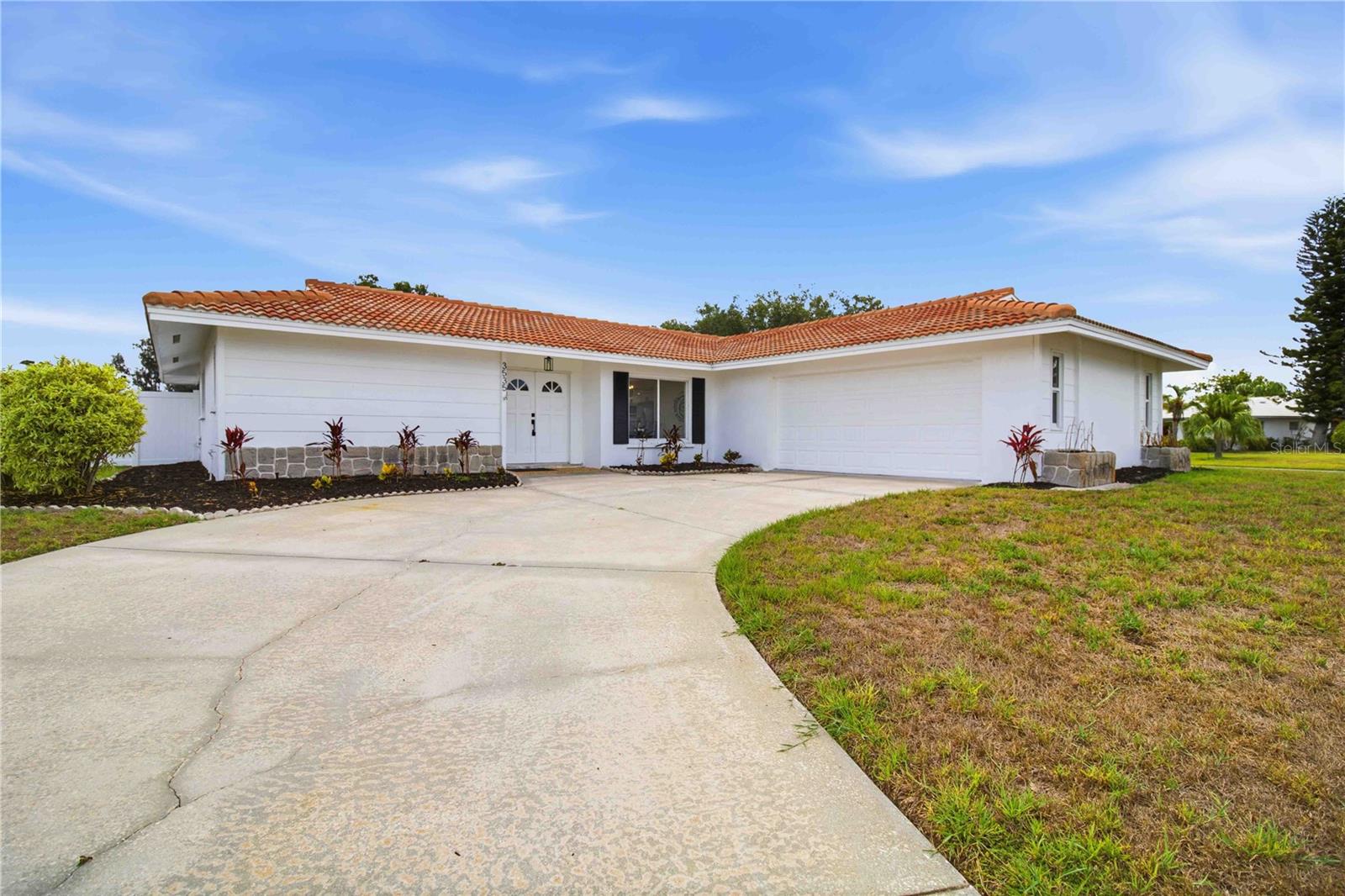 STUNNINGLY RENOVATED HOME IN THE HIGHLY DESIRABLE VILLAGE GREEN ESTATES! Situated on a premium oversized lot, this beautifully updated 3-bedroom, 2-bath residence delivers the perfect blend of luxury, comfort, and location. From the moment you arrive, the fresh landscaping, updated exterior, and BRAND-NEW VINYL PRIVACY FENCE create incredible curb appeal and backyard seclusion. 
Inside, you’ll find a completely reimagined interior with designer finishes throughout. The show-stopping kitchen features elegant waterfall quartz countertops, soft-close cabinetry, premium finishes, and an open-concept design ideal for entertaining. Wide-plank luxury vinyl flooring flows seamlessly throughout the home, accented by stylish matte black fixtures and hardware for a modern, sophisticated feel. 
Both bathrooms have been transformed into spa-inspired retreats with custom tile work, upscale vanities, and contemporary finishes. The spacious living areas open to a screened and covered lanai, creating the perfect indoor-outdoor Florida lifestyle. Major upgrades provide peace of mind, including impact windows and doors, newer tile roof, new HVAC ductwork, and new water heater — making this home truly move-in ready. Located in the well-established Village Green Estates community with only a low $100 annual fee and NO CDD fees. Optional membership at the nearby Village Green Golf Club offers easy access to golf just moments away. Exceptional Sarasota location close to shopping, dining, Starbucks, Publix, Legacy Trail, Downtown Sarasota, UTC Mall, I-75, and world-famous Siesta Key Beach.