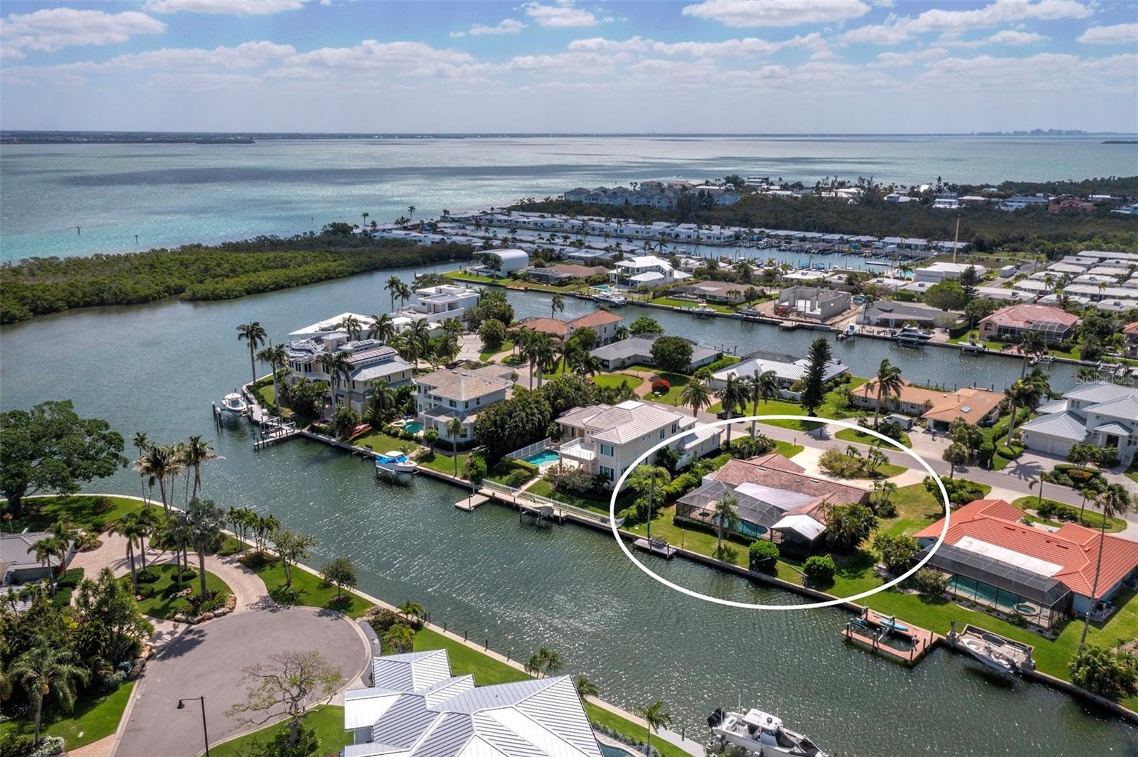 Exceptional opportunity to own a Longboat Key waterfront home in the highly desired community of Emerald Harbor. This 3BR/2BA, 1,926-sf canal front home with pool sits on an oversized 100x155-ft lot along one of Longboat’s widest canals (~110 ft) offering deep-water boating access just a half mile to the Intracoastal Waterway. Private beach access with parking is less than half a mile away. The property experienced storm-related water damage in 2024 and is ready for renovation or a brand-new custom home build. Enjoy island living close to The St. Regis Longboat Key Resort, The Resort at Longboat Key Club, St. Armands Circle, and North Longboat Village favorites—Shore, Mar Vista, Whitney’s, and Lazy Lobster. Emerald Harbor Longboat Key home for sale combines boating, beach access, and the ultimate Florida lifestyle—an unbeatable fixer-upper Longboat Key canal-front opportunity in one of the island’s premier neighborhoods.