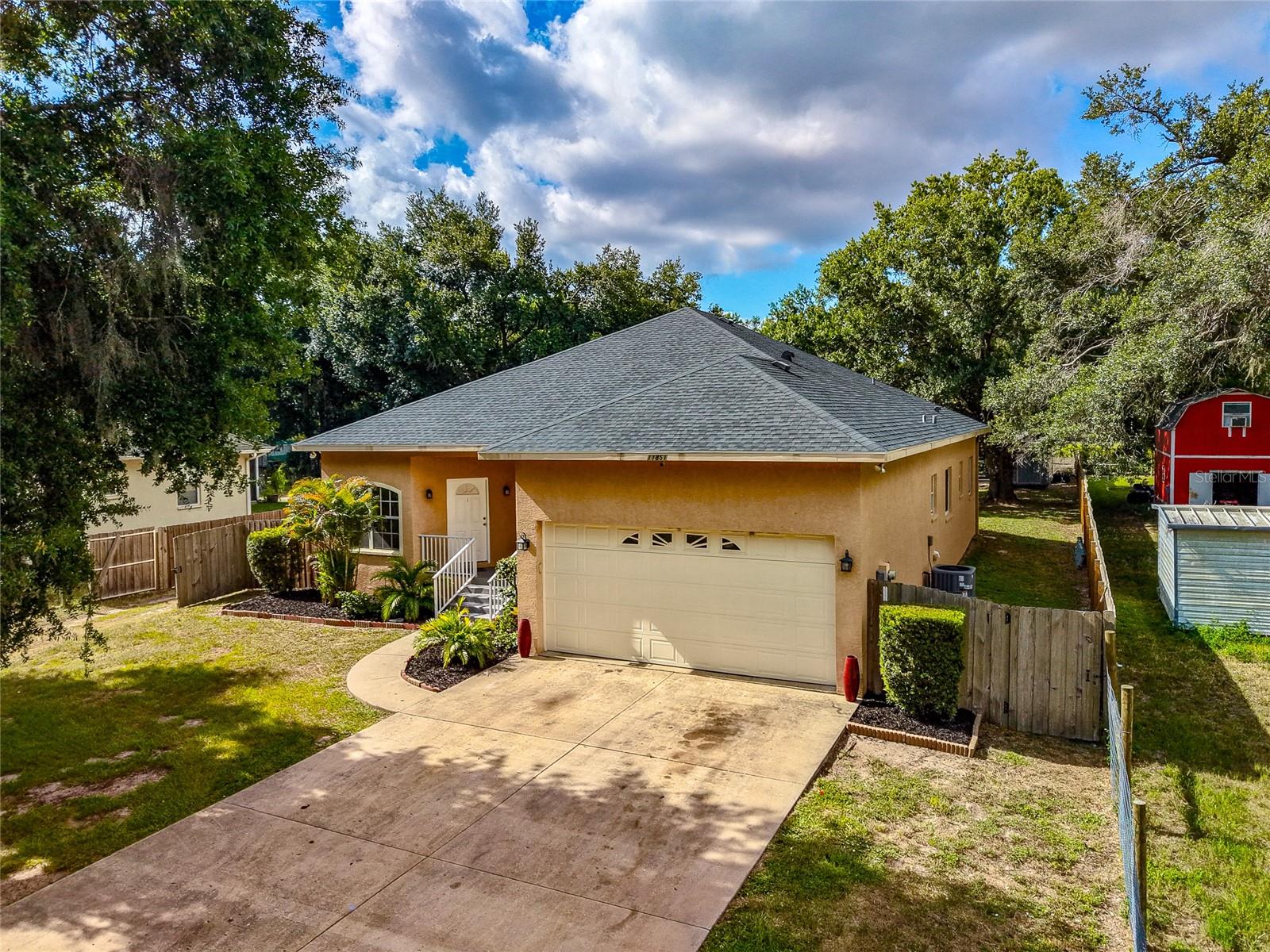 Don't miss this incredible opportunity to own a spacious 3-bedroom, 2-bathroom single-family home in one of Parrish's most desirable locations, just minutes from the thriving North River Ranch community! Situated on over half an acre, this property offers the freedom of NO HOA, NO CDD fees, and no deed restrictions—giving you the flexibility to truly make it your own. Inside, you'll find a bright, open floor plan featuring a welcoming living and dining area that overlooks the screened lanai and expansive fenced backyard, creating the perfect setting for relaxing or entertaining. The spacious primary suite offers dual walk-in closets, private access to the lanai, and an ensuite bath complete with dual vanities, a separate walk-in shower, and a luxurious garden tub. This home also includes a separate family room and formal dining area, providing multiple living spaces. Outside, the possibilities continue with an extended private driveway and a large fenced backyard. A detached two-car carport/pole barn with partial enclosure offers endless potential for a workshop, hobby space, storage, or additional recreational use. Conveniently located near top-rated schools, parks, shopping, dining, and everything the growing Parrish area has to offer, this property combines space, privacy, and an unbeatable location.  Schedule your private showing today!