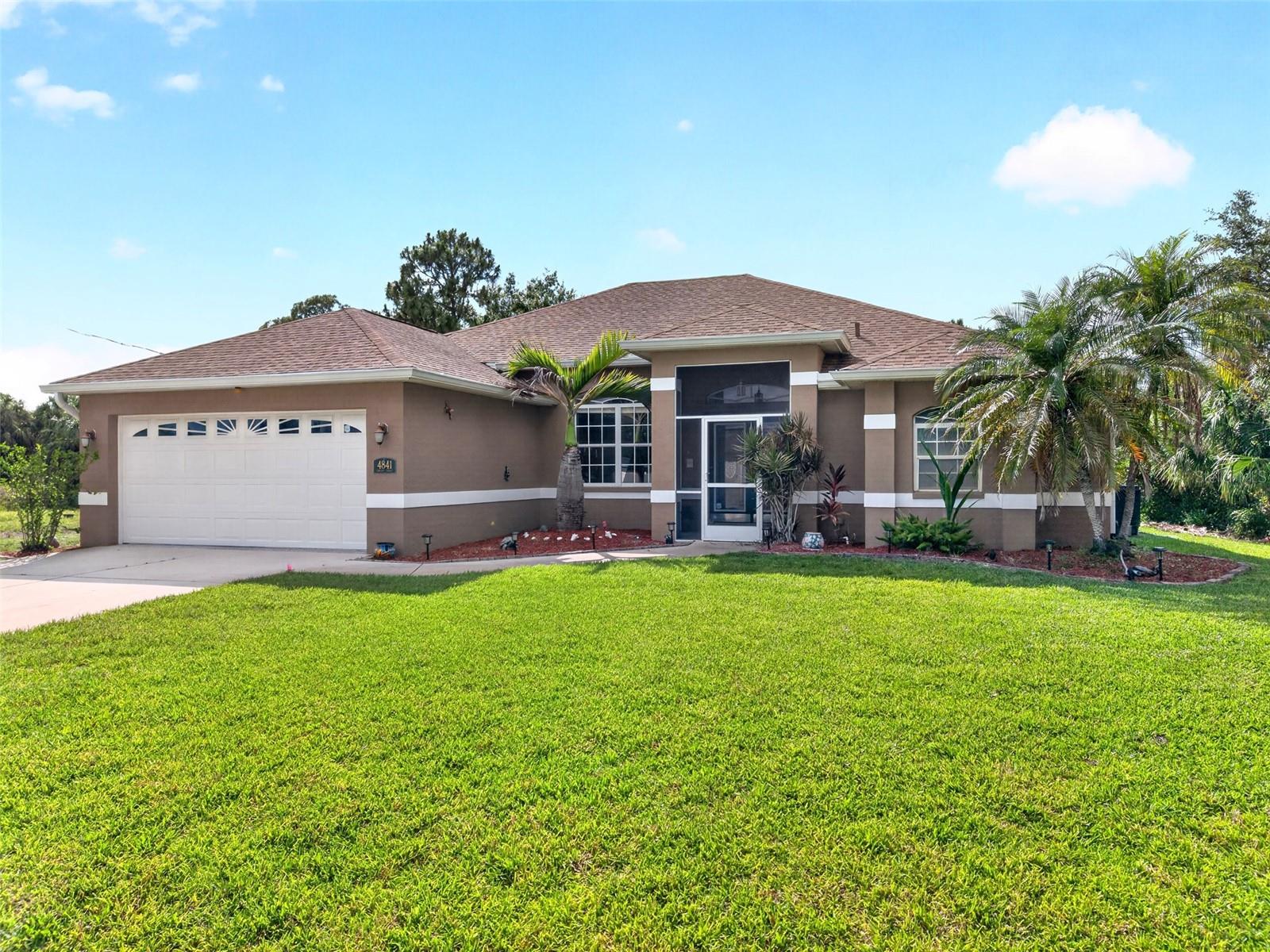 MULTI-LOT OPPORTUNITY IN NORTH PORT! UNMATCHED PRIVACY & POTENTIAL with over 30,000 SQ FT TOTAL LAND! This 3 bedroom, 2 bath, 2 car garage, pool home includes the separately deeded, lot next door and lot behind the home! Open, split floor plan features high ceilings and ample natural light creating a bright and airy ambiance. As you step inside, you're welcomed by the living and dining rooms, which offer views of the lanai and pool. These spaces flow effortlessly into the kitchen which offers white cabinetry, solid surface countertops, closet pantry, breakfast bar and eat in kitchen perfect for entertaining. Generous primary bedroom features direct access to the lanai/pool, his and her walk-in closets and private ensuite bath with dual sinks, soaker tub, walk-in shower, and water closet for privacy. Split floor plan ensures ultimate privacy for guests with two additional bedrooms, one with a murphy bed. Both guest bedrooms share a full guest bath. Step outside to your own private retreat, where outdoor living meets ultimate relaxation. The beautifully paved, covered, and screened lanai creates a seamless indoor-outdoor lifestyle, perfect for hosting or simply soaking in the serenity. Beyond the screened swimming pool, an open lawn awaits. Framed by a private perimeter of mature trees, this spacious yard offers an estate-like buffer with endless possibilities. It provides the perfect space to build, or the unique flexibility to sell off the extra lots in the future. Whether you're entertaining or soaking in the serenity, this outdoor space invites you to enjoy the tranquility of surroundings. Additional features include a water softener, newer roof (2022), irrigation system around whole house, and no HOA fees or CDD. Nestled on a quiet street you'll enjoy the peace of suburban living while still being just minutes away from shopping, dining, and everyday conveniences with easy access to Route 41. With North Port's affordability, friendly atmosphere, and strong community feel it's easy to see why so many are choosing to call this area home. Don’t miss this opportunity! Schedule your private showing today!