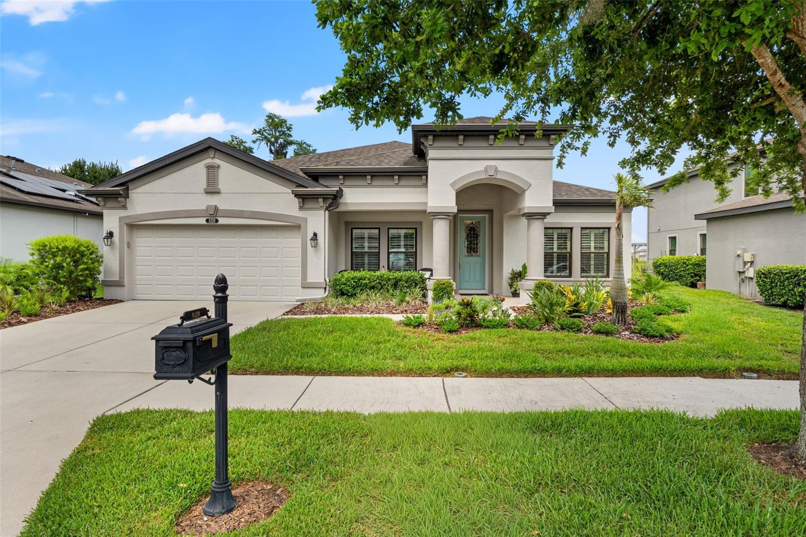 There is something special about coming home to a place where the pace slows, the views never grow old, and every space has been thoughtfully designed for the moments that matter most.Positioned on a premium conservation homesite with no rear neighbors, this beautifully curated residence offers over 2,400 square feet of thoughtfully designed living space, where every room was created to bring people together while still providing quiet places to retreat.Morning begins with coffee overlooking the preserve as sunlight pours through plantation shutters and fills the open living spaces. Wide-plank wood-look tile leads you effortlessly through the home, while designer lighting and timeless finishes create an atmosphere that is both refined and welcoming.Just beyond the foyer, a pair of French doors opens to a private office—an inspiring space to work from home, create, read, or easily accommodate overnight guests when needed.The heart of the home is unmistakably the kitchen. Gather around the oversized quartz island while meals are prepared among stainless steel appliances, decorative tile accents, and abundant cabinetry. The seamless connection to the dining area and great room ensures every conversation continues long after dinner is served.The owner's suite is quietly tucked away, offering uninterrupted views of the sparkling pool and protected conservation beyond. Designed as a true retreat, the spacious suite features an oversized walk-in closet and a spa-inspired bath complete with dual vanities, a soaking tub, and a walk-in shower—creating a peaceful place to begin and end each day.Outside is where this home truly comes alive.Designed for effortless Florida living, the screened lanai unfolds into a private backyard sanctuary centered around a stunning 30-foot heated saltwater pool with a sun shelf, swim-out bench, and tranquil conservation backdrop. Whether spending quiet afternoons floating beneath blue skies or hosting unforgettable evenings with family and friends, every detail invites you to slow down and stay awhile.The custom outdoor kitchen transforms entertaining into an experience, featuring a built-in Blackstone griddle, beverage refrigerator, sink, generous prep space, and mounted television—allowing every gathering to flow naturally from indoors to out while overlooking the peaceful beauty of nature.Practical luxury has not been overlooked. A tandem three-car garage offers exceptional flexibility with built-in storage, an EV charging station, gas generator hookup, and water softener, while fresh interior paint, updated lighting, reclaimed irrigation, and numerous thoughtful improvements make the home completely move-in ready.Life in Connerton extends well beyond your front door. Residents enjoy a collection of resort-caliber amenities including a clubhouse, expansive pool, splash park, fitness center, tennis and basketball courts, scenic walking trails, parks, and playgrounds—all thoughtfully woven into one of Land O' Lakes' most sought-after master-planned communities.This is more than a beautifully maintained home. It is a place where mornings begin in quiet serenity, afternoons are spent poolside beneath the Florida sun, and evenings become lasting memories shared with the people who matter most.