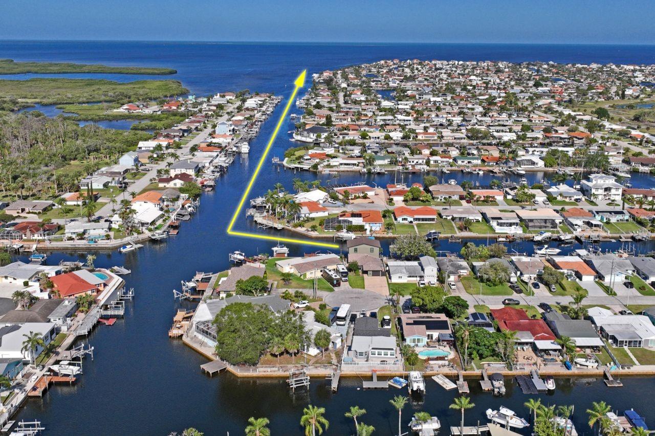 LUXURY PARADISE HOME WITH SUPERIOR WATER VIEWS.  Ask about the boat, which is not included in the list price.
The open floor plan is perfectly laid out with superior quality from top to bottom.  This home has been completely remodeled and a second floor added in 2025 with the degree of excellence that shows in every aspect.  The gourmet kitchen includes creamy light cabinetry, a farm sink and a hand-crafted kitchen island that gives this home that special touch.  There is also a separate butler pantry/laundry room with additional cabinetry and counter space.  The dreamy living room includes special touches that include a cozy book reading nook, a child's cubby play area under the staircase, and blue tooth speakers in the ceiling.  
Once you walk through the living room’s sliding glass doors, you walk out to the large Lanai with stained concrete flooring, plenty of seating areas, a stone outdoor kitchen, a spa pool, and electric-powered screens and shutters.  Additional outer living space leads to a lower level with a sunshade and composite wood decking.  Further, all of the aluminum railings have pine tar coating to ensure no rusting.  The 50’ seawall includes a composite wood dock with a 4-year old boat lift and remote that lifts up to 12,000 pounds, a floating dock, and a dual wave runner floating dock. 
The powder room and primary bedroom are located just off of the living room and the bedroom not only has a very large walk-in closet with custom cabinetry, an en-suite with a separate luxury walk-in shower, solid-wood and stone dual sink vanity, and a private water closet, but it also has a sliding glass door that lead out to the Lanai.
The same superior quality extends to the 2nd floor which has multi levels.  The lower level has a combination family room/office, a bedroom, and a full bathroom.  The upper level has a game room and another bedroom. The western side of this 2nd floor has sliding glass doors that lead to a balcony to enjoy those gorgeous views even more.  The 2nd floor also offers a secret access by hydraulic stairs between the lower and upper levels that lead to the finished attic with additional storage.
The entire home was sprayed with foam insulation, all the walls, windows, doors, ducting, electric, plumbing, water heater, appliances, lighting, and fixtures were replaced in 2025.  Additional quality of construction includes floated floors that are sealed to the concrete and flood dam doors.
The Gulf Harbor Community is a golf-cart-friendly community that offers a Community Center and 2 boat ramps at an optional $100.00 annual fee.  This community, of course, is located on the Gulf of America, is within walking or golf cart distance to shopping, a short distance to Gulf Harbor Yacht Club, downtown New Port Richey, nature preserves, and major roads that lead to other Florida destinations.
This home has it ALL!  Call me for immediate access and start living your dream.
