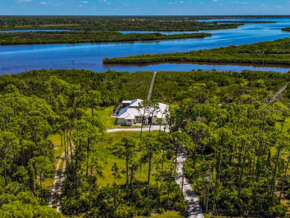 BUYERS - The Video Tour includes a short home review and price analysis. If your agent does not see this listing in their MLS, share this listing with them so they can schedule a showing. Buyers may also schedule showings or submit offers directly through the official listing page for this home.



The sign, ''Welcome to our Riverfront Home,'' greets you upon entrance into the beautiful foyer through the double entry doors, setting the tone for this 2.69-acre waterfront property. Key features and updates include:

- A new metal roof installed in 2023.
- A new septic tank (2025), three new well pumps (2025), and a well and water treatment system with a 500-gallon RO storage tank hidden inside a neat wood cabin structure.
- The entire home has been painted with non-toxic paint from Sherwin Williams, and new fans have been installed in every room.
- New luxury vinyl plank flooring throughout the entire home.
- The entire upstairs window wrap is impact glass, as are several windows on the main floor.
- New five-panel solid core doors, new trims, and ample storage throughout.

The home is a four-bedroom residence with five sets of sliders along the back opening to the pool/spa patio area, overlooking the mangroves. There is 300 feet of dock access through the mangroves.

The large pool/spa patio area includes a brand-new enclosure, a solar outdoor shower, and a new tongue-and-groove lanai ceiling with fans. The heated salt water pool and spa feature a waterfall for added ambiance.

The kitchen has been completely remodeled with new cabinets, granite counters, a tumbled stone backsplash, a Sub-Zero refrigerator, a copper sink, and a wine cooler.

The primary en-suite bedroom is located on the main floor and offers three walk-in closets, a soaking tub niche with a TV, and a separate shower with a frosted glass enclosure. All main floor bedrooms have large walk-in closets.

The charming staircase leads to the fourth bedroom upstairs, which features its own newly screened patio space with panoramic views and an en-suite shower bathroom.

This is an equestrian community with beautiful homes on large acre-plus lots. There are no mandatory HOA or CDD fees. The road is privately owned by the community, with a voluntary association for shared road paving responsibility.

This country living is less than 20 min. from Englewood Beach and 10 minutes from Costco and dining, shopping, and live entertainment in the new Downtown Wellen Park. The Englewood Sport Complex, which features 18 pickleball courts, is also only 10 minutes away.