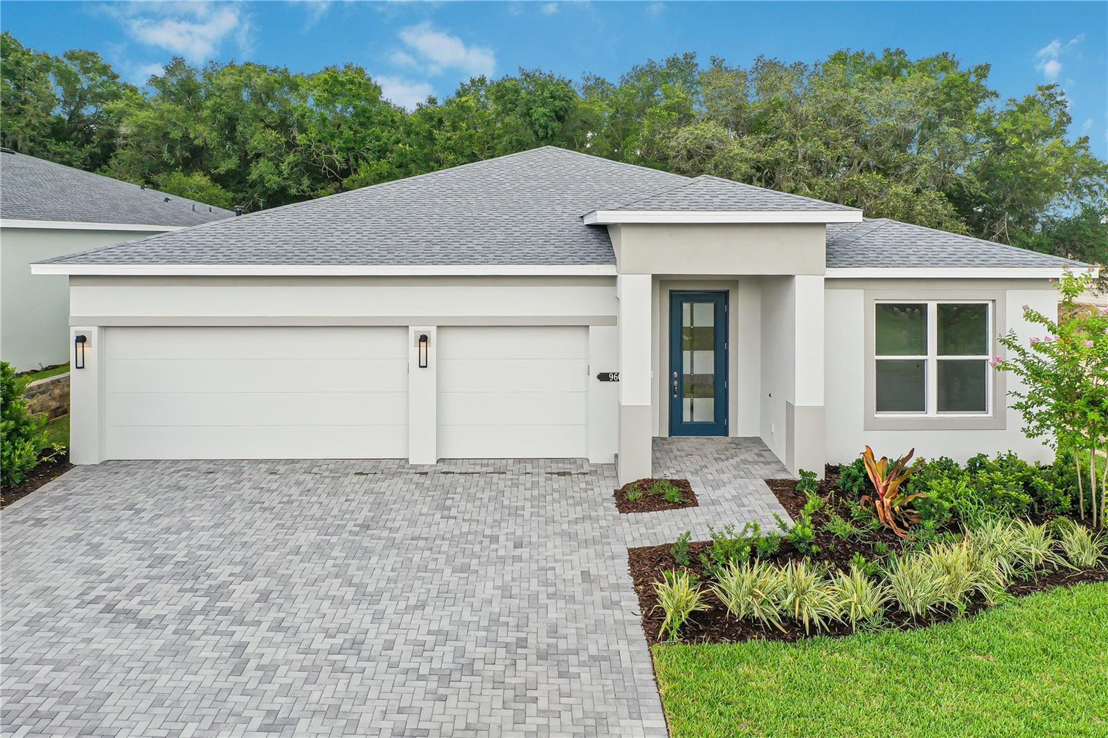 One or more photo(s) has been virtually staged. This move-in ready home in Lady Lake, FL features the Pearl floorplan with 3 bedrooms, 3 bathrooms, a flex room, and a 3-car garage with a functional, livable layout, located within Cresswind Hammock Oaks, a 55+ community. Designed with separation between primary and secondary living spaces, the home balances openness with everyday comfort and practicality. The open-concept layout centers around an expanded great room and dining area measuring over 25 feet wide, creating a spacious main living area with direct access to the outdoors. A 16-foot wide by 8-foot tall sliding glass door leads to a covered lanai with a 5-foot privacy wall, supporting indoor-outdoor living and added seclusion. The kitchen features a fully upgraded design with consistent finishes throughout, including a cooktop cabinet with drawers, tall oven cabinet, GE appliances with a 30" cooktop, and a large center island designed for both prep and gathering. The layout is designed to maximize functionality while maintaining a clean, modern aesthetic. The owner’s suite is privately positioned at the rear of the home and includes unique convenience features like direct laundry access from the walk-in closet, supporting easy day-to-day living. The spa-style owner’s bath also features an extended owner’s shower, while a transom window adds natural light to the owner’s closet for a brighter and more open feel. Two secondary bedrooms are located toward the front of the home, each with access to a full bath, while the flex room offers additional versatility for a home office, den, or hobby area. Additional highlights include a designer glass front door, upgraded finishes throughout, and a layout intentionally designed for long-term livability and comfort. Set within an active adult community in Lady Lake, residents have access to a clubhouse, fitness center, and a variety of amenities designed for everyday living and connection. See Community Home Guides for details.