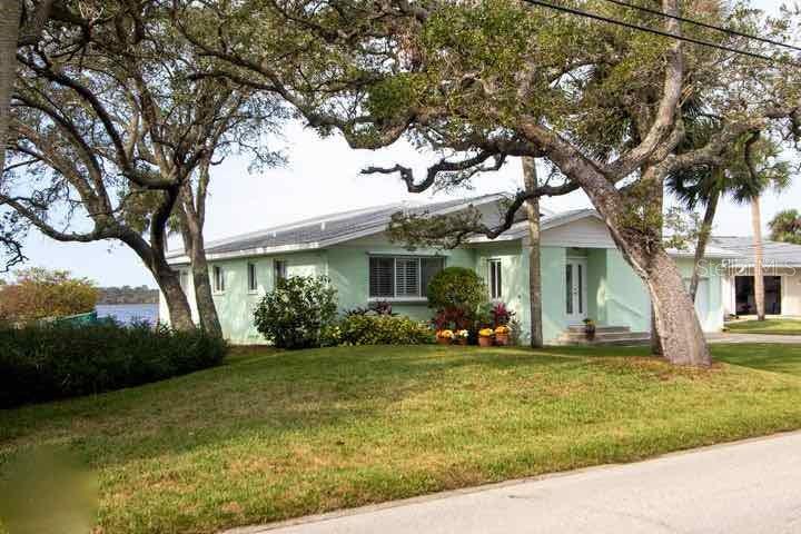 Open living area, amazing ICW views, updated master bath, hardwood floors in living areas and 2 guest bedrooms. Large open kitchen with wet bar or prep sink & quartz countertops & Hickory cabinets. Dock with lift and electricity and water. Property's West view is the quite Tomoka Park. Retaining wall with deadmen for extra strength. Property has never had water intrusion in the living area. One of the guest bedrooms is an ensuite with small refreshment bar and sitting area with access to porch. Property has shallow well irrigation system & new pump; 2022. Master bedroom is large with direct access to waterfront porch. New carpet; 2022. Exceptional walk-in closet with custom built-ins. Closet has an HVAC duct as well as a glass block window. Master bath has custom cabinetry with raised sink ;Water: City