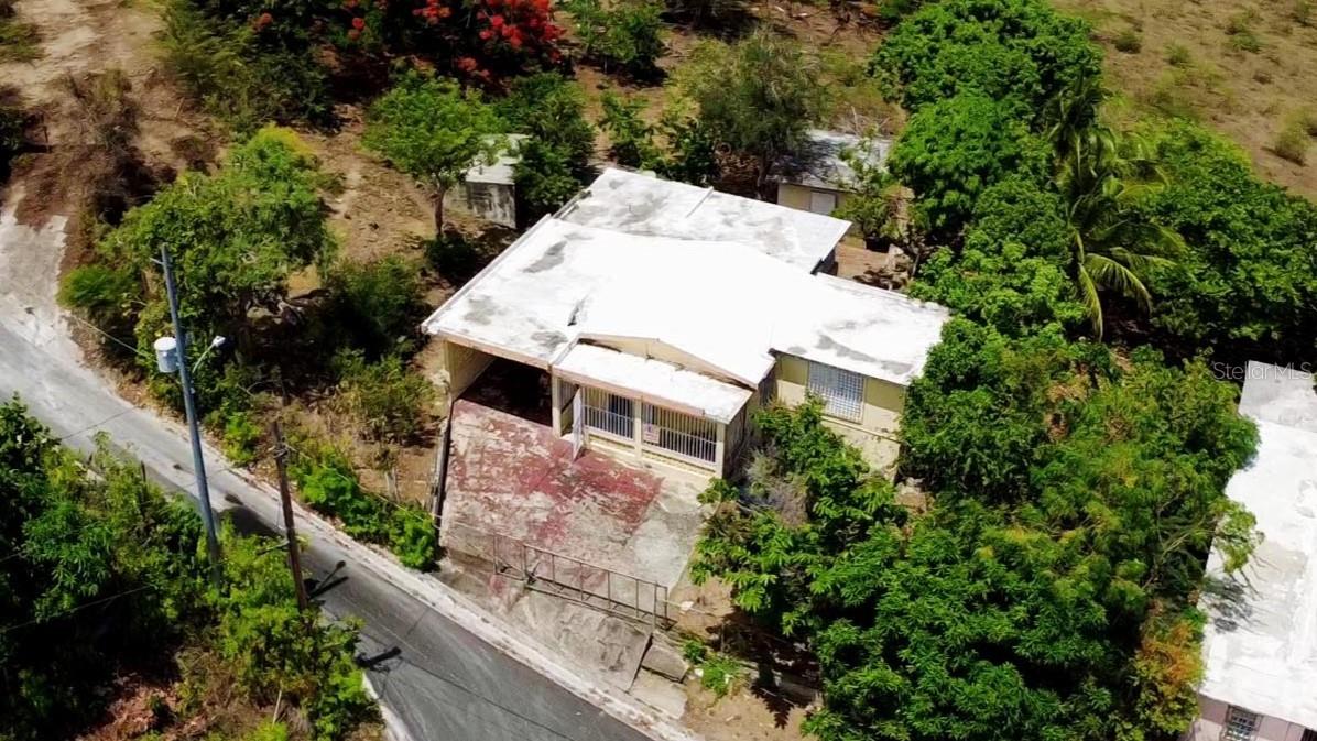 Welcome to this amazing opportunity in the beautiful community of Destino! The house is an original PRRA with an addition, 2 bedrooms and 1 bathroom.  It is hard to find views like this, especially at this price! Approximately 1.5 acres provides incredible views on the south side of Vieques. You can see the small islands in front of Esperanza and  the sea that stretches to the horizon.

An enclosed laundry room is located off of the back balcony. Two extra subdivided spaces are next to the living room, creating areas for office or whatnot. There is a carport and front balcony where you can also take in the views. The house needs work, but has potential and is a great investment opportunity. A second driveway leads into the top of the property where there is a perfect area for additional developement to take full advantage of the views. Add a pool, gardens, and more! Just behind the house is a shed that could be used for storage, or a workspace. Plenty of mature fruit trees dot the landscape, including a few mango, anon, tamarind, avocado and acerola. Located mid island, it is easy to get to the north and south side beaches, dining and stores in approximately 10 minutes.

There are two additional structures on the property and 2 cisterns, making it ready for a multitude of dream projects! Much more to this property than meets the eye, a must see!!