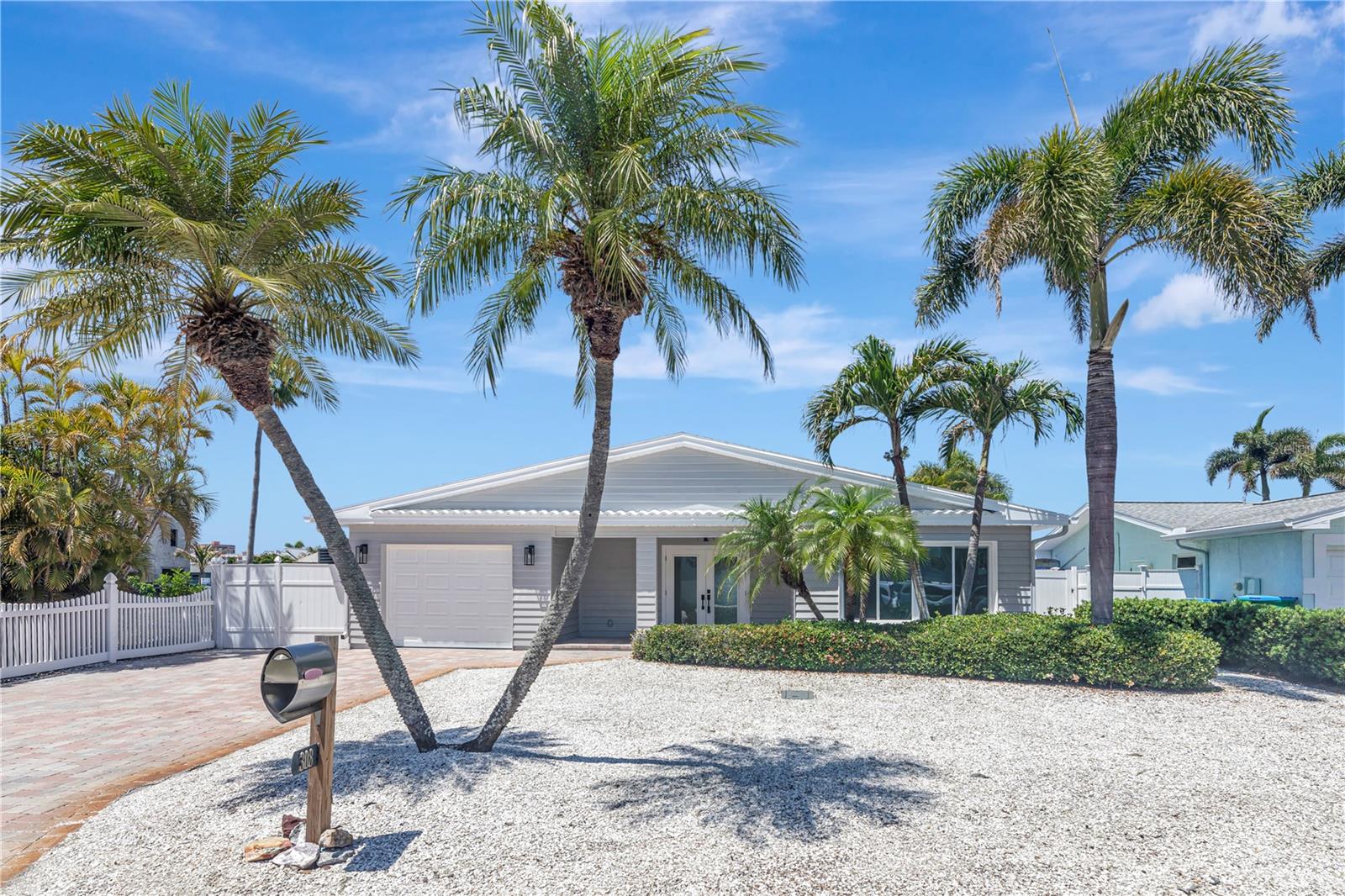 BIG PRICE IMPROVEMENT! Location, Location, Location!! Beautiful fully renovated WATERFRONT home in North Redington Beach featuring 2 bedrooms 2 baths and over 1500 sq/ft of living space with an OPEN FLOOR PLAN. Nearly everything is BRAND NEW! NEW PAINT inside and out! NEW AC. All new laminate plank flooring throughout. All new kitchen with quartz counters and backsplash, upgraded cabinets and drawers with soft close, crown molding, LG stainless steel appliances and wine cooler. Spacious primary suite featuring walk in closet with built in custom closet system. Upgraded primary bathroom with dual sinks and walk in shower. All new doors and light fixtures throughout. Outside is a waterfront oasis featuring sweeping WATER VIEWS, brand new deck, a fire pit, tropical landscaping, and dock with 12,000lb boat lift. 1 car attached garage with brand new opener. Amazing location, walking distance to the soft white sand beaches of the GULF. Group Flood Insurance Policy INCLUDED until 11/27/27 at no cost to buyer! This home feels like it's BRAND NEW and is ready for it's new owner. One or more photo(s) has been virtually staged