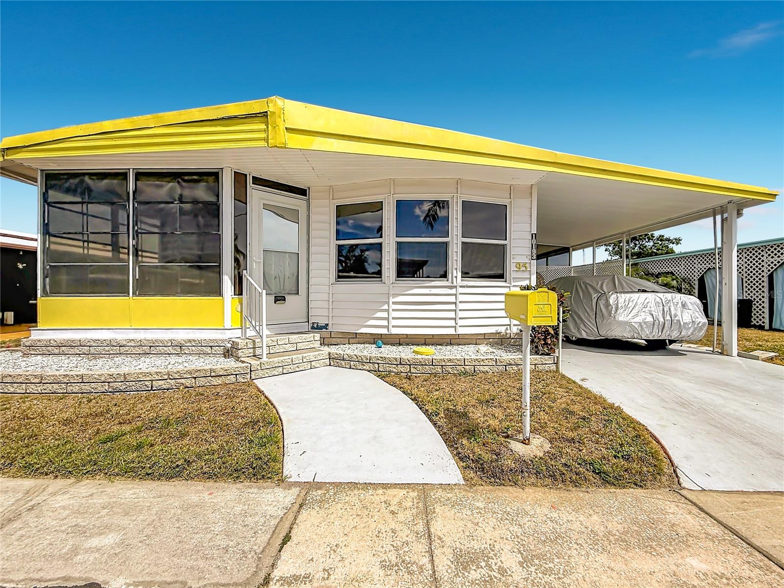 ADORABLE beachside cottage feel—light, bright, and full of charm! Located just 5 miles from the sugar-sand shores of Indian Rocks Beach and only a quick 10-minute drive to world-famous Clearwater Beach, this home offers the perfect blend of coastal living and everyday comfort.

Inside, you’ll find updated windows with professional tint and custom shades, allowing for abundant natural light while reducing glare and enhancing privacy. Stylish newer vinyl flooring flows throughout, complemented by a newer refrigerator and a brand-new hot water heater (2026).

Start your mornings in the sun-filled dining area, where ample windows offer a small view of the sparkling water perfect for enjoying your coffee. The main bathroom has been tastefully updated with a newer vanity and walk-in shower, while the primary bedroom features generous closet space and an updated ensuite half bath.

The exterior boasts durable vinyl siding and a private screened-in patio—ideal for relaxing during Florida’s beautiful winters. Furnishings are negotiable (with some exclusions), making this an easy move-in opportunity.

Located in the desirable Holiday Shores community, residents enjoy an active lifestyle with low HOA fees of just $200/month, covering water, sewer, twice-weekly trash service, and full lawn maintenance. Amenities include a putting green, shuffleboard courts, library, fitness center, and a full calendar of social events. Boating enthusiasts will appreciate the private boat ramp and first-come, first-served slips.

Conveniently situated about 30 minutes from Tampa International Airport and Clearwater/St. Pete Airport, this location offers easy access to everything the Gulf Coast has to offer. Please note: the community is currently undergoing sewer pipe upgrades at no cost to residents, with full restoration of the grounds upon completion.

Don’t miss your chance to own this bright and breezy coastal retreat!