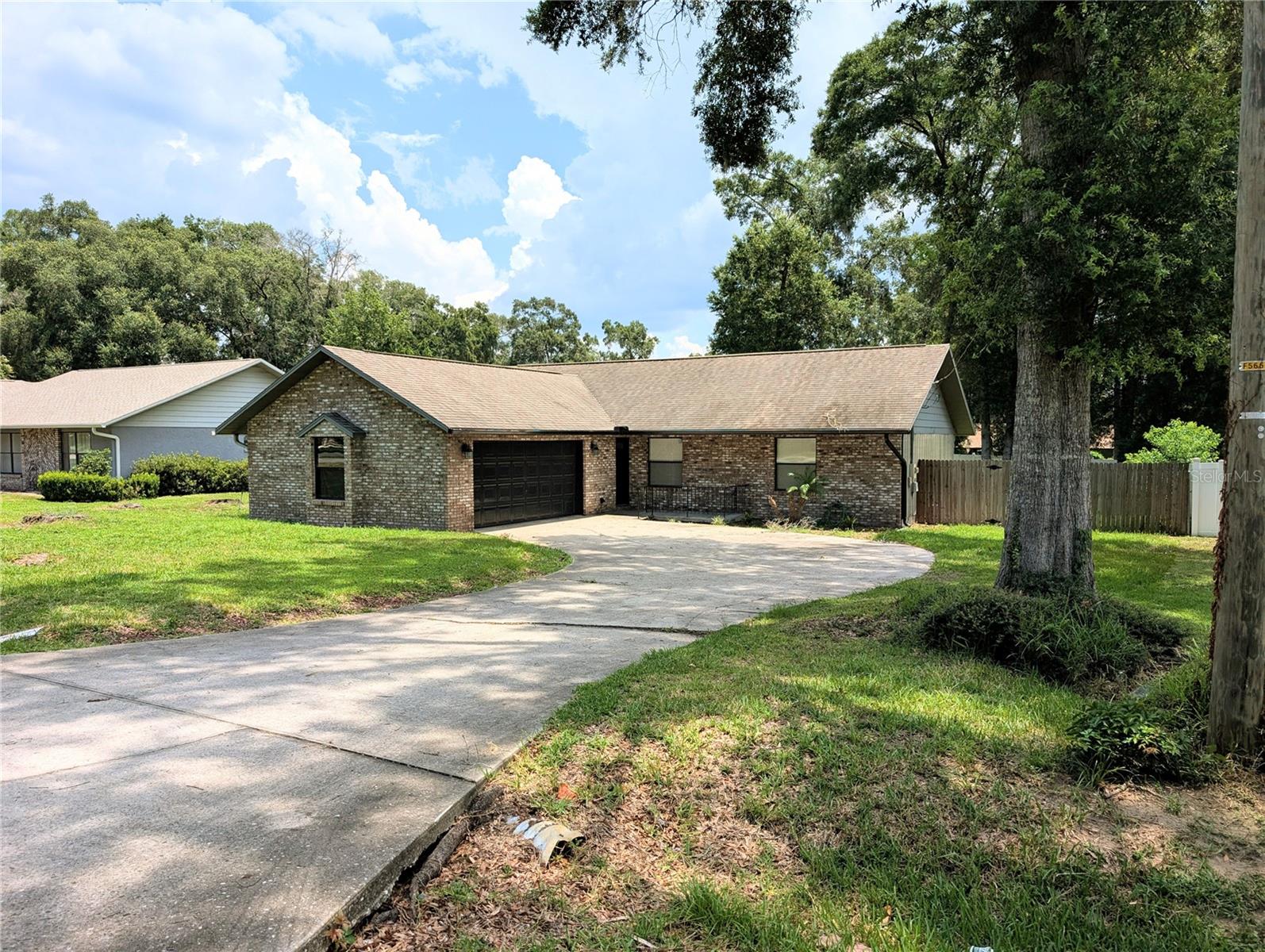 UNMATCHED CONVENIENCE!  Welcome home to this inviting 3 bedroom, 2 bath home with an over-sized two car garage, perfectly located just outside the Ocala City limits and NO HOA!! Enjoy the best of Central FL with Publix only 2 minutes away, historic Downtown Ocala just 9 minutes away, the world-famous Silver Springs State Park only 8 minutes away, and Daytona Beach just an hour's drive.
Inside, you'll find oversized bedrooms and a large garage, offering plenty of space for comfortable living and storage. Step outside to a large, fully fenced backyard featuring mature shade trees, a small citrus tree, and a cozy firepit--- perfect for entertaining family and friends or relaxing under the stars.  The screened-in back porch provides the ideal spot to enjoy peaceful Florida evenings without the bugs. 
Outdoor enthusiasts will love the easy access to nearby lakes and rivers for boating, fishing, kayaking, and countless recreational adventures.  Whether you're looking for convenience, outdoor living, or a place to call home, this property offers it all!!