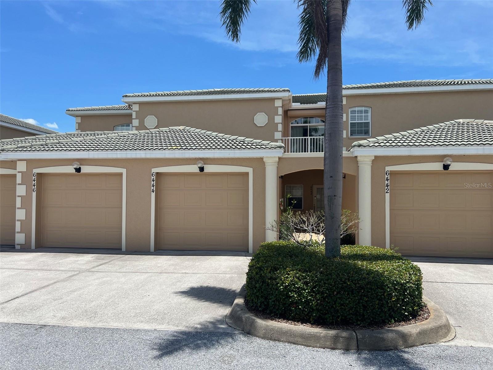 One or more photo(s) has been virtually staged. Drastic Price Reduction! SELLERS MOTIVATED! Just installed, brand new neutral carpet and paint! Looking for a quiet west Bradenton condo with views? This one enjoys superior, 2nd floor elevated views where from the screened lanai, enjoy views overlooking the 5 acre lake, the fountain, and the walking trail. From the entry use the newly carpeted stairs up BUT keep in mind there is also A CUSTOM ELECTRIC CHAIR LIFT AVAILABLE. This was recently removed and stored in the garage but can easily be RE-installed free of charge at the request of a buyer. This allows effortless transport to the 2nd floor for residents or just use carry cargo such as groceries to the open and bright newly painted living level. The kitchen has tons of storage, has upgraded cabinetry, granite cuntertops, and is just steps from the expansive living and dining spaces. This freshly painted 3 bedroom unit has 2 baths that feature granite vanity tops and the primary bath has a walk-in shower. Bedroom windows feature plantation shutters.There is a one car private attached garage and a driveway for a second car. The inside laundry area comes with a washer and dryer included. There are hurricane rated curtains on the lanai and a robust roll up hurricane shutter for the sliding glass door off the front balcony. There is even a generator hook-up on the front balcony for your convenience should one ever need it. The monthy hoa fee covers your trash pickup, water and sewer, cable and internet, building insurance and exterior maintenance, and use of all of the community recreational and exercise facilities. The modern clubhouse is just a short walk from your front door. Come take a swim or a relaxing soak in the hot tub, use the abundant exercise facilities, or maybe just stroll around the lake on the paved path. What's not to like? There is even a Home Warranty! Come see this one today!