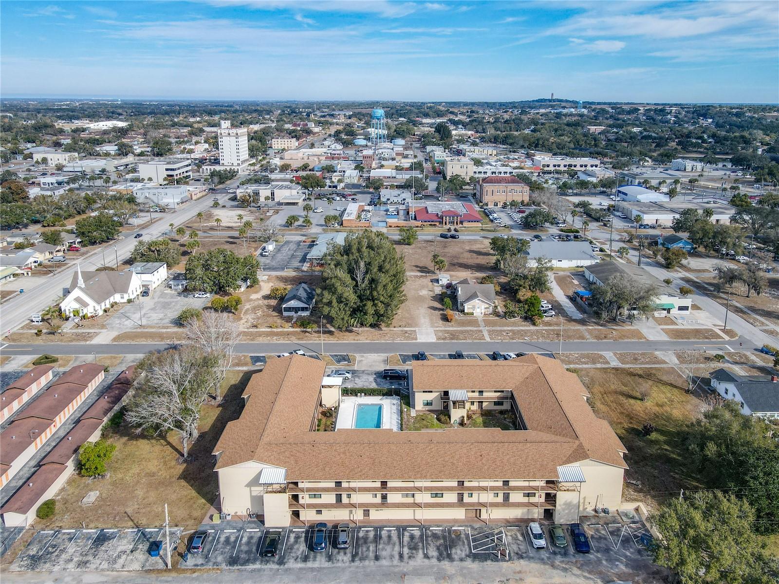 Welcome to Lake Wales Village Condominium, a quaint 55+ condo complex located in the heart of Lake Wales, Florida! This community has a great location, just blocks from the main downtown area, and minutes to Bok Tower Gardens (you can see the carillon in the first aerial photo), shopping, and dining! This top floor (of two floors), end unit, condo has been gutted and remodeled, and is ready for its new owner! The kitchen features painted cabinets (that look great), beautiful granite countertops, and new stainless steel appliances. There is space for a small breakfast table in the kitchen as well, and a pass-through to the main living space. The great room features space for a dining room and living room, and a set of sliding glass doors leads you to the screened in porch (with green space as your view, versus streets that other sides of the buildings have). Both bedrooms are spacious, with the guest bedroom in the back of the condo and master suite in the front. The living room and both bedrooms have ceiling fans, and new laminate flooring flows throughout the home. The guest bathroom has a shower / tub combo, and the master has a walk-in shower. The condo has a meeting room, plus swimming pool! Laundry is available (units are not allowed to have their own laundry units). Concerned about the ever increasing condo fees? The fees for this condo actually DROPPED from last year (from $425 to $413 per month)! The monthly fee covers water, sewer, trash, grounds and exterior maintenance, and amenities. This is a great opportunity to buy a remodeled and worry-free condo for yourself or for a loved one! Schedule your showing today!