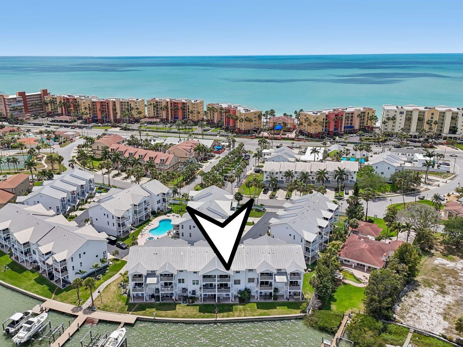 Indulge in the pinnacle of coastal luxury in this exceptional waterfront townhome located within the exclusive, gated enclave of The Tides Village Yacht Club. Offering direct water access and sweeping, unobstructed views, this residence captures the essence of refined Gulf Coast living—where every sunrise and sunset becomes a daily masterpiece.

Designed with both elegance and functionality in mind, this three-bedroom, two-and-a-half-bath home features a two-car garage, plus downstairs bonus room, and a private elevator providing seamless access to all levels. From the moment you enter, you are welcomed by an expansive open-concept living space, highlighted by soaring ceilings, abundant natural light, and thoughtfully curated architectural details.

The chef’s kitchen is both sophisticated and inviting, complete with generous workspace, a breakfast bar for casual dining, and effortless flow into the main living area—perfect for entertaining or quiet evenings at home. A fireplace and built-ins add warmth and character, while multiple balconies extend the living space outdoors, offering tranquil settings to enjoy coastal breezes and panoramic water views.

Step outside to your private waterfront retreat, where direct access to your dock and patio creates a seamless connection to the Intracoastal lifestyle—ideal for boating, paddleboarding, or simply unwinding by the water’s edge.

The top level featurs all bedrooms, including the luxurious primary suite, a serene escape featuring a spacious layout, walk-in closet, and a spa-inspired bath with dual vanities, a soaking tub, and separate shower. A private balcony completes the suite, offering peaceful water views and the perfect place to begin or end your day. Two additional guest bedrooms, a full bath, and a conveniently located laundry area provide comfort and privacy for family or visitors.

Residents of this boutique waterfront community enjoy exclusive access to a heated pool and spa, along with the peace of mind of gated security. Ideally located just moments from fine dining, boutique shopping, and pristine Gulf beaches, this home offers an unparalleled blend of luxury, privacy, and convenience.

This is more than a residence—it is a statement of lifestyle. A rare opportunity to own a premier waterfront property in one of North Redington Beach’s most coveted communities.