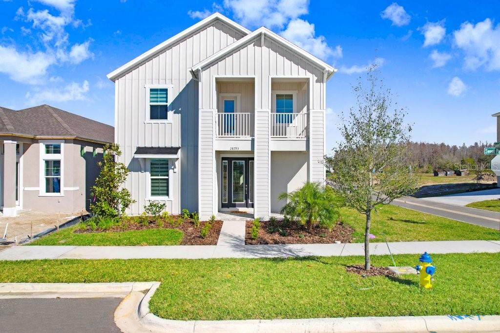Welcome to this exquisite Corner Home in the coveted community of The Persimmon Park. Conveniently located within proximity to Wesley Chapel’s Top-Rated Wiregrass Schools, near I75 on SR56 and minutes from Wiregrass Mall, Advent Health & BayCare Hospitals, The Grove for shopping, Wiregrass Sports Complex, Tampa Premium Outlets, Restaurants & so much more! There are 5 Bedroom, 4 Full Bath and 2 car garage. This home features a stunning master suite downstairs, it has a huge walk-in closet, stand up shower, enclosed toilet and two separate vanities. Three other bedrooms upstairs, one has walk-in closet and a bathroom inside, the other two have a bathroom that they can share, next to the spacious loft that can be used as a game room, movie room or even library. There is a bedroom downstairs with a closet which can be used as an in-law suite or guest room with a full bathroom next to it. The HOA FEE INCLUDES lawn mowing, some landscape maintenance, yearly fertilization & mulching and basic internet. This beautiful home offers, ample natural light and ventilation and provides a comfortable haven for your whole family to enjoy the perfect Florida lifestyle.
