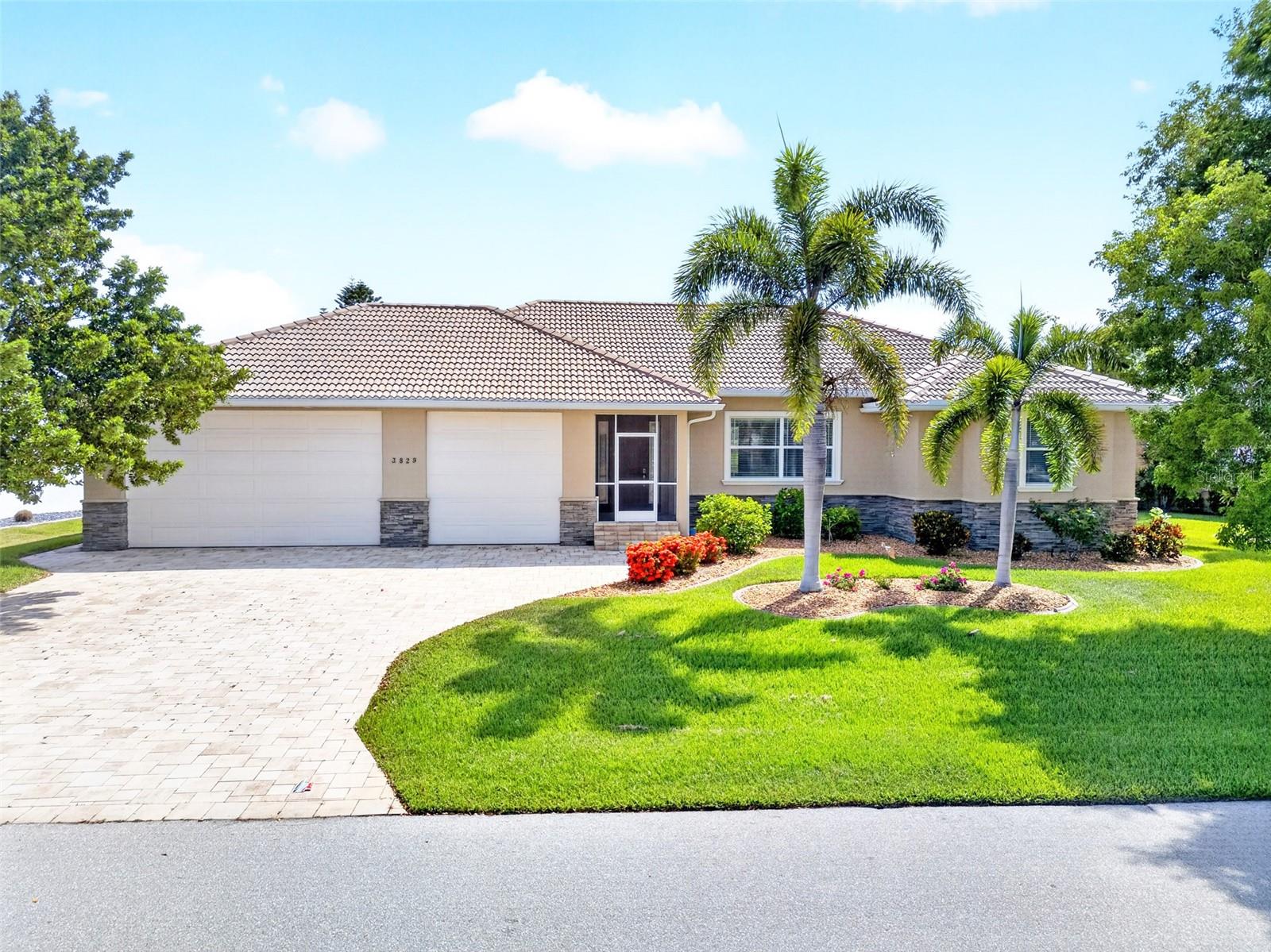 Burnt Store Isles! Immaculate 3-bedroom, 2-bath, 3-car garage, pool home on the beautiful Twin Isles Golf Course with expansive views of the 13th hole! Inviting entryway leads you to an open floorplan with double tray ceilings, crown molding, contemporary lighting, and tile flooring throughout. The living room features an 8’ zero-corner slider to the lanai seamlessly blending indoor and outdoor living spaces. Gourmet kitchen offers wood cabinetry with pull out drawers, complemented by a tile backsplash and granite countertops. The large island, closet pantry, gas cooktop and gas oven enhance its functionality. Luxurious primary suite has a backlit tray ceiling, direct access to the lanai/pool area, and two walk-in closets. The private ensuite offers dual vanities, a soaker tub, walk-in tile shower, and a water closet for added privacy, along with two linen closets. Split floor plan is designed for optimal privacy, featuring two additional guest bedrooms sharing a well-appointed guest bath that also doubles as the pool bath. Spacious laundry room includes a sink, cabinets, drying bar, linen closet, and an extended home office space. Step outside to your private oasis, where the covered, screened lanai and heated pool and spa are perfect for entertaining guests. This outdoor area is surrounded by sealed pavers, while the wood-paneled ceiling adds a coastal touch to the space. Whether you’re looking to unwind or host a crowd, the pool and spa offer year-round enjoyment with the flexibility of both gas and solar heating options. Beyond the lanai, the fenced-in yard provides a lush, scenic backdrop that will appeal to golfers or anyone who appreciates a serene view. Additional seller features and upgrades include a reverse osmosis system in kitchen, pull-down stairs to the attic, entryway closet plus two linen closets in the guest hallway for extra storage, irrigation system, propane tank pad large enough for a second tank. The oversized 3-car garage with epoxy flooring, 10’ doors and 14’ ceilings with one bay being 30’ deep is an amazing feature. Why pay extra to store your boat or RV when you can easily store them here. Located in a popular deed-restricted boating and golf course community with optional memberships at the Country Club. Enjoy an 18-hole championship golf course, swimming pool, tennis complex, and a spacious clubhouse with dining and social events. This home is truly one of a kind with a short drive to restaurants, shopping, The Yacht Club, Fishermen's Village, and historic downtown Punta Gorda. Don't miss out on the opportunity to make this home your new Florida retreat. Schedule your private showing today!