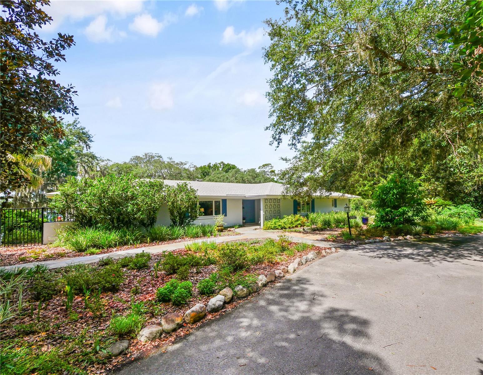 Rare opportunity to own a breathtaking, very private three-acre lakefront estate. This stunning property offers a park-like setting with expansive flower beds, gardens, an edible food forest with citrus, tropical fruit, figs, mulberries, blackberries, and majestic live oaks overlooking a beautiful ski lake. Located on Deep Lake in Oviedo, this 42-acre lake has an excellent water-quality rating, 239 feet of waterfront, two docks, and a double boathouse. The ranch-style home has been impeccably maintained with newer flooring, roof, A/C, pool resurfacing and equipment, primary bath, plantation shutters, and fresh interior and exterior paint. Enjoy water sports on the lake or relax beside the oversized, screened, solar-heated lap pool. Gardeners will appreciate the private potting shed, while hobbyists will enjoy the workshop connected to the extra-large detached two-car garage. Come see this exceptional home, offering pride of ownership, top-rated schools, and convenient access to the 417 Expressway, restaurants, and shopping.