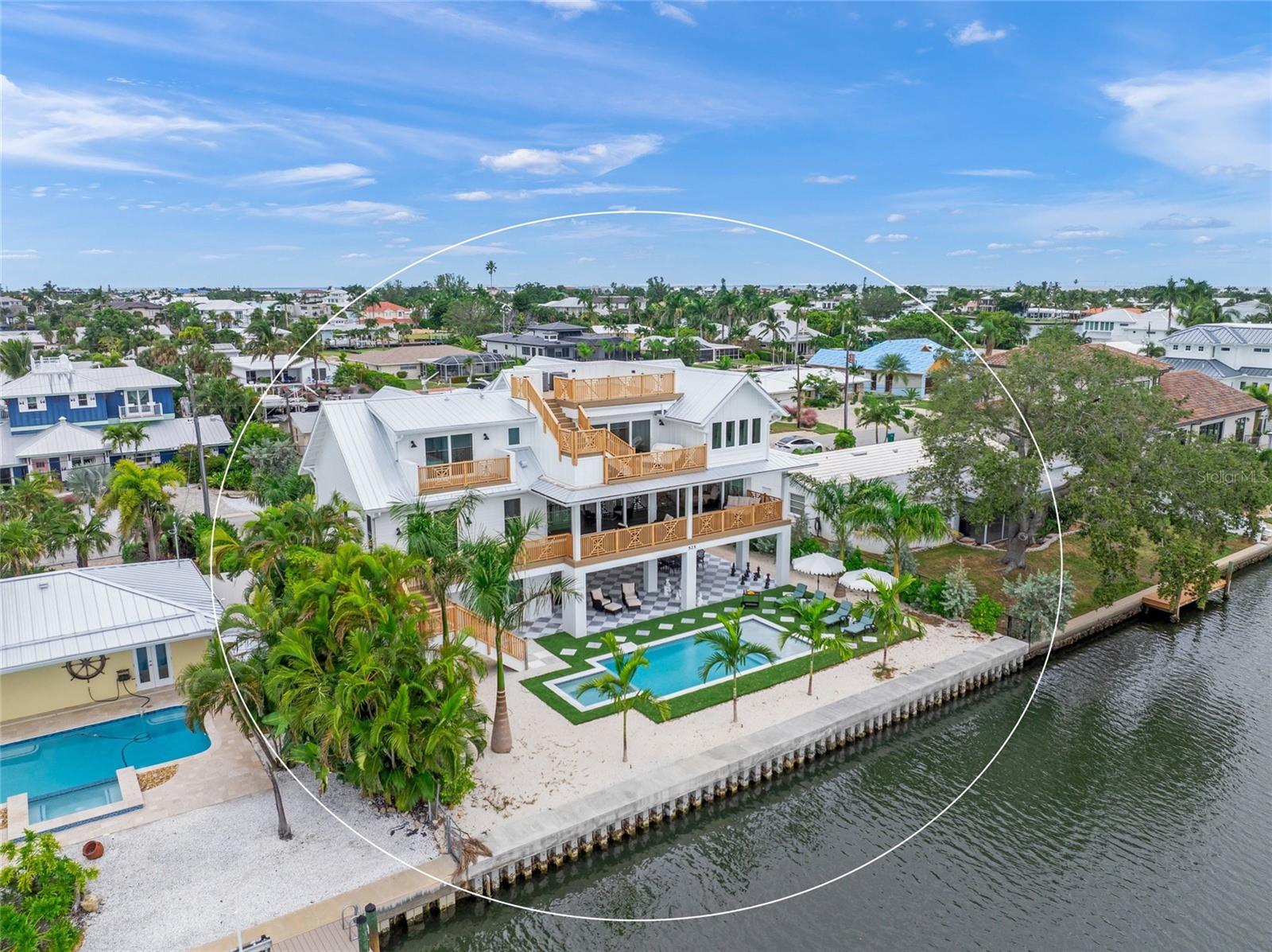 Just Completed Coastal Southern Retreat on the Grand Canal!

Welcome to 525 68th Street, an elegant newly completed Southern-style residence perfectly positioned along the coveted Grand Canal in Holmes Beach. This 4-bedroom, 4.5-bath masterpiece offers timeless charm blended with modern coastal luxury. Each spacious en suite bedroom exudes comfort and style, while a private study provides the perfect quiet escape.

The open-concept chef’s kitchen is designed for entertaining, featuring premium appliances, custom cabinetry, and designer finishes. An elevator connects all levels, leading to expansive porches and a stunning rooftop deck with panoramic views of Tampa Bay and the Gulf of Mexico—ideal for sunset gatherings or morning coffee.

Step outside to your private oasis—lush tropical landscaping surrounds a heated pool and spa, creating a serene setting for relaxation or waterfront entertaining. With some of the best boating water on Anna Maria Island and quick access to the Intracoastal and Gulf, this property is a boater’s dream.

Beautifully designer-furnished and move-in ready, this home invites you to enjoy island living at its finest—just moments from the charming shops, restaurants, and sugar-sand beaches of Holmes Beach. Spend your holidays in pure coastal elegance!