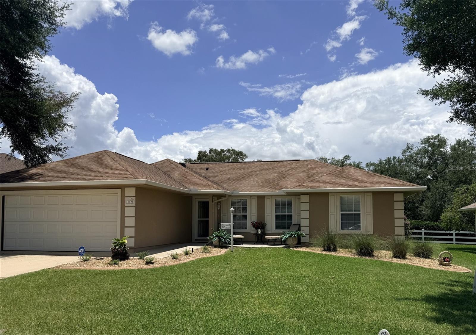Enjoy the best of an active resort living in Stonecrest, a gated 55+ community featuring a champion golf course and outstanding amenities. 
With endless activity and social opportunities, you'll feel like you are on vacation year round. We are so close to The Villages!!
This beautiful maintained 3-bedroom, 2-bath, a desirable, soaring ceiling through out. The bright eat-in kitchen, bay window, pantry, cabinets, granite countertop with coordinating back splash, ample cabinetry , and a convenient  and a pass through window, great for entertaining guest.
Formal dining room showcases elegant wall paneling and the wall and French doors.
Living room with fantastic laminated floors through out the house, windows the bring in the natural light into this home. 
Spacious Primary Suite includes a walk-In closet, fan and blinds.  En-suite with large walk in shower, separate vanity area, and a private water closet. 
Two comfortable guest  bedrooms are conveniently separated by a well-appointed guest bath for privacy and family visitors. 
 Additional features inside Laundry room with washer, dryer, and ample storage space.  Lanai is off the dining room, passed the French Doors. The lanai has tile floors, fan, sliding plexiglass locking windows. Gorgeous hedge off the lanai for privacy. A door way opens to the patio were grilling your favorite foods and relaxing can be fun. 2 Car Garage with  Epoxy striking easy to maintain floors and a  Utility sink, garage has so much storage and an electric garage screen door is included...
Front door has a storm door, Roof  2021, A/C 2016, 2 Skylight, 

HOA FEE $152.00 and month includes: 4 Pools (1-indoor ), Jacuzzi, Pickleball Courts, Baseball field, Pond for catch and release fishing, Dog park, Shuffle Board, 50 Clubs, Fitness Center, Club House and so much more!
Close to The Villages, Restaurants, Doctors Offices, Hospital, Publix, Hair and Nail Salons, The V.A. There is RV Parking which is not included in the HOA FEE.   PROFFESSIONAL PHOTOS TO ARRIVE JUNE 15,  Thank You