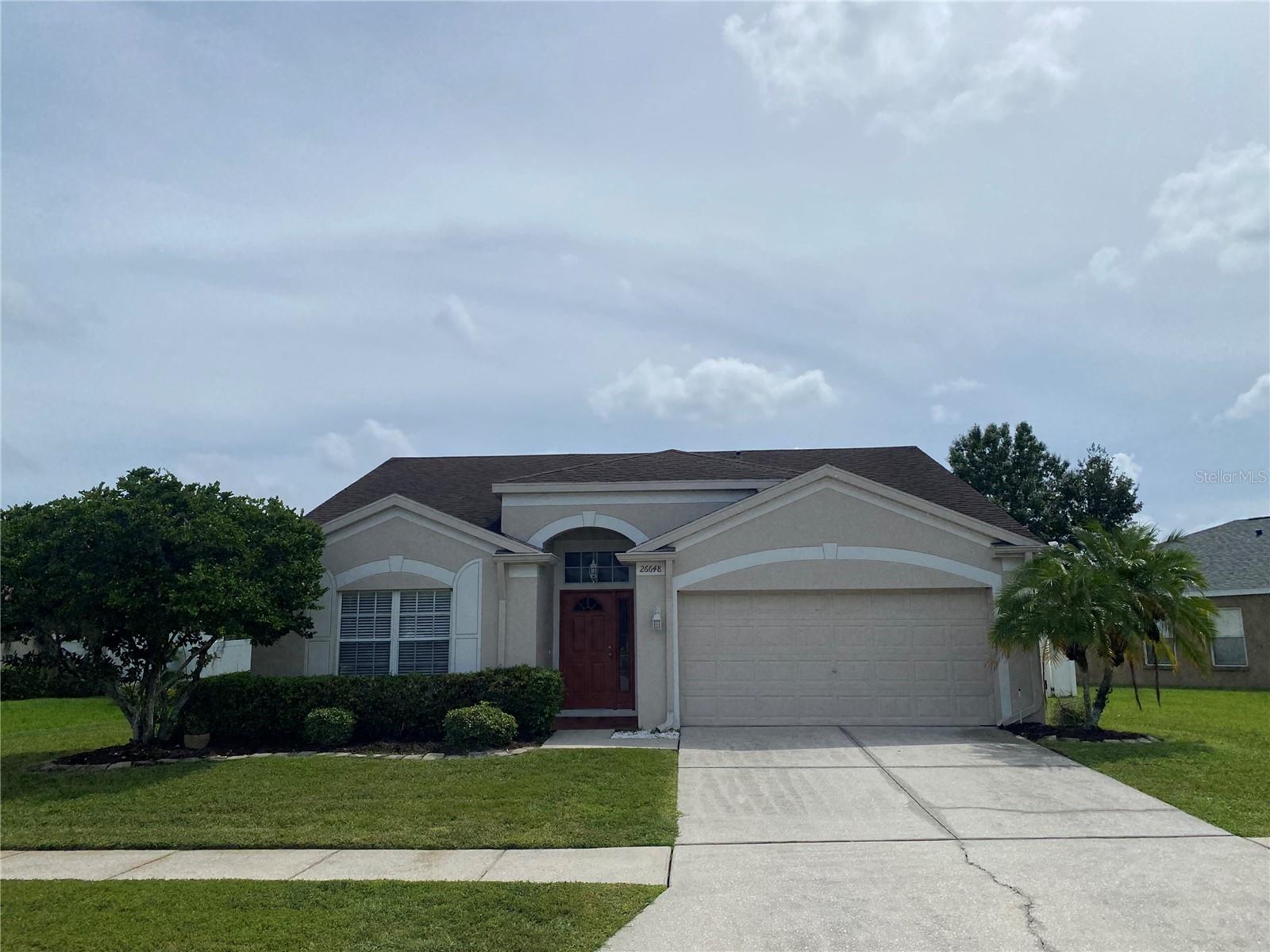 A GREAT opportunity is calling you to live in LEXINGTON OAKS! Don't let this one slip by you! This 3 bedroom 2 bath home features a SPACIOUS, open floor-plan with volume/vaulted ceilings, extensive wood laminate flooring, and ceiling fans throughout. The eat-in kitchen boasts TILED COUNTER-TOPS, breakfast bar, pantry, and a complete set of appliances! Gorgeous m/bath includes a garden soaking tub, walk-in shower, double sink vanity, water closet for the toilet, and a multi-shelved walk-in closet. Through the french doors is a LARGE SCREENED LANAI with tile flooring and a ceiling fan! Privacy vinyl fenced rear yard - bring your pet! Great community with several amenities including a resort style community pool! Great house - great location! Property is being sold “AS-IS” with right to inspect. It is the buyers and buyer’s agent responsibility to verify all room measurements, utilities info, lot size, schools zoning, building addition permits, building materials, along with all property information in this listing. All room measurements and dimensions are estimates.