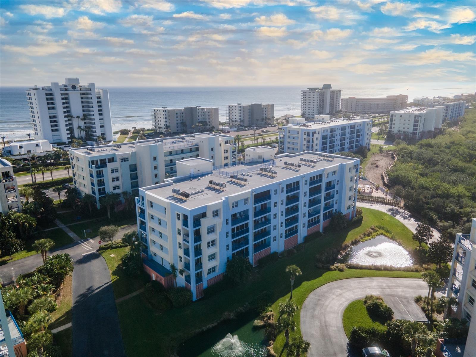 Welcome home to this beautifully maintained, never rented, 3 bedroom, 2 bath condo within the resort-like lifestyle of Ocean Walk. Comes furnished, making it completely turn-key and perfect for living year round, leasing and for vacation rentals. Sliding doors from the large master take you to the screened in balcony overlooking both a pond and the estuary. Master bath includes double vanities, a shower, deep tub and plenty of storage. Home features a 2018 AC unit, storm door, cable & wifi included in the association fees, sleeper chair in the living area, extendable dining table to seat 8 and a spacious laundry room. There is a large storage unit on your floor and covered parking with elevators from the parking garage. Make your way across the street by way of the complex's deeded access to the beach. Preferred building location directly next to one of the pools and clubhouses. Ocean Walk's 5-star amenities include: two pools, two clubhouses, bbq grills, 2 lighted tennis courts, shuffleboard, basketball court, jacuzzis, and a walking trail. Your maintenance free New Smyrna Beach getaway awaits you! ;LocationDescription: Condo ;Water: City