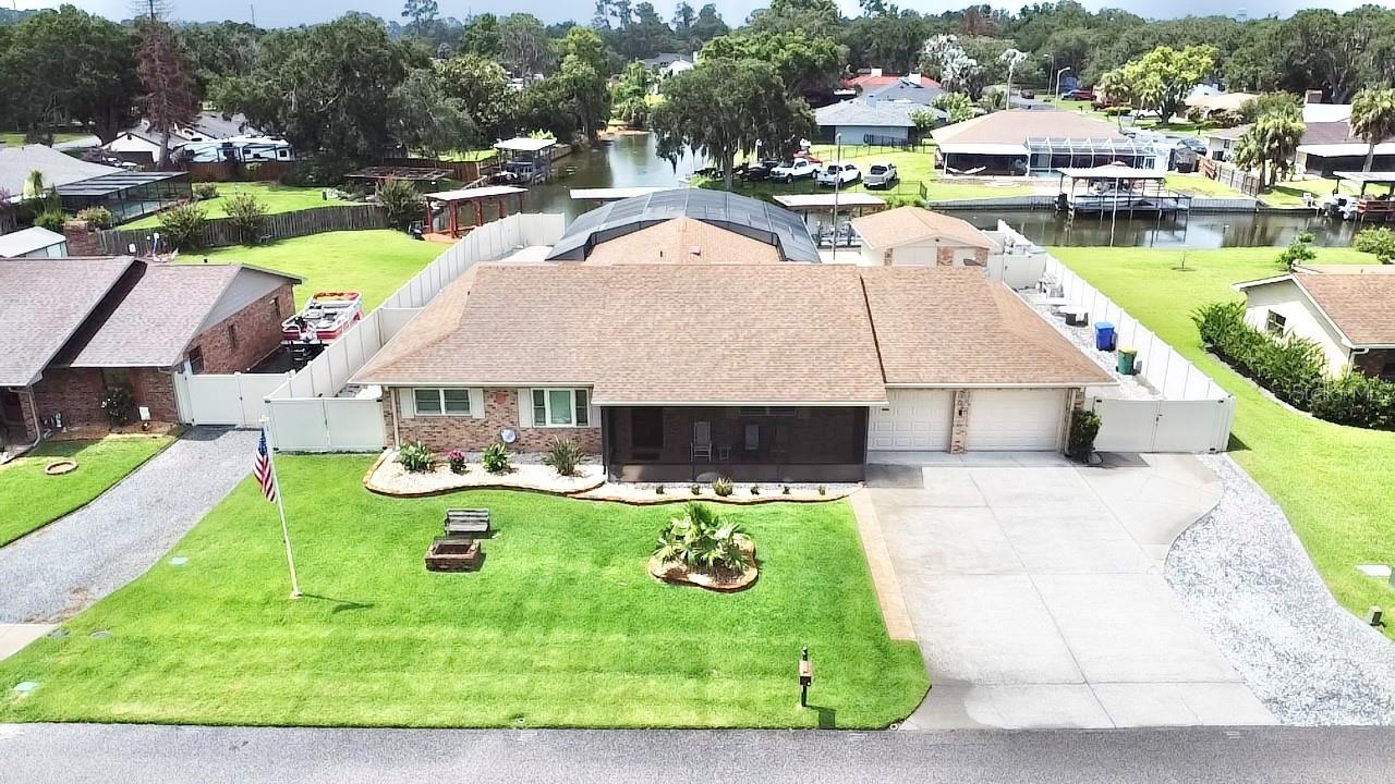 WELCOME TO YOUR PRIVATE WATERFRONT RESORT ON THE HARRIS CHAIN OF LAKES!

This exceptional canal-front estate was thoughtfully designed for the buyer who wants it all—BOATS, RVs, COLLECTOR CARS, WORKSHOP SPACE, AND RESORT-STYLE OUTDOOR LIVING.

Located on a WIDE CANAL WITH VIEWS TOWARD LAKE EUSTIS and featuring 108 FEET OF CANAL FRONTAGE, this meticulously maintained home offers quick access to the renowned Harris Chain of Lakes. Cruise to OVER A DOZEN WATERFRONT RESTAURANTS, MARINAS, AND ENTERTAINMENT DESTINATIONS directly from your backyard.

Unlike many open lakefront homes, the protected canal location provides calmer waters, easier docking, and convenient boat access while still offering immediate access to open water.

The home offers 3 bedrooms, 2.5 baths, a split-bedroom floor plan, formal dining room, spacious living areas, and a beautifully remodeled kitchen featuring GRANITE & QUARTZITE COUNTERTOPS, CUSTOM CABINETRY, DESIGNER BACKSPLASH, and stunning waterfront views.

The real showstopper is the incredible outdoor entertainment area featuring nearly 3,000 SQ. FT. OF SCREENED LIVING SPACE complete with:

• SALTWATER POOL & SPA
• ELECTRIC & GAS POOL HEATERS
• OUTDOOR KITCHEN WITH TEC INFRARED GRILL
• ELECTRIC AWNING
• OUTDOOR SHOWER
• PERMANENTLY CONNECTED PROPANE FIRE PIT
• CUSTOM PRIVACY CURTAIN SYSTEM
• BEAUTIFUL CANAL VIEWS

Need space for your toys? This property delivers:

• AIR-CONDITIONED 3-CAR GARAGE
• AIR-CONDITIONED WATERFRONT WORKSHOP (EASILY CONVERTED TO ADDITIONAL GARAGE SPACE)
• PROFESSIONALLY BUILT RV PARKING PAD
• 50-AMP RV SERVICE
• TONS OF STORAGE
• GENERATOR-READY ELECTRICAL SYSTEM
• NO HOA

Boaters will appreciate the DOUBLE BOATHOUSES, TRI-TOON LIFT, SEAWALL, and direct access to the HARRIS CHAIN OF LAKES.

Additional upgrades include ANDERSON IMPACT WINDOWS, IMPACT SLIDERS, NEW TRANE HVAC SYSTEM, NEW DUCTWORK, MINI-SPLIT A/C SYSTEMS, CUSTOM WINDOW TREATMENTS, EXTENSIVE ELECTRICAL UPGRADES, PVC FENCING, and LOW-MAINTENANCE LANDSCAPING.

Located in one of Tavares’ most established waterfront communities, where pride of ownership is evident throughout and many residents have called the neighborhood home for decades.

Located in a GOLF CART FRIENDLY COMMUNITY just minutes from downtown Tavares, the Seaplane Capital of the World, you’ll enjoy easy access to waterfront dining, festivals, shopping, and entertainment.

EVERY DETAIL REFLECTS QUALITY, CRAFTSMANSHIP, AND PRIDE OF OWNERSHIP. THIS ISN’T JUST A HOME—IT’S A WATERFRONT LIFESTYLE.