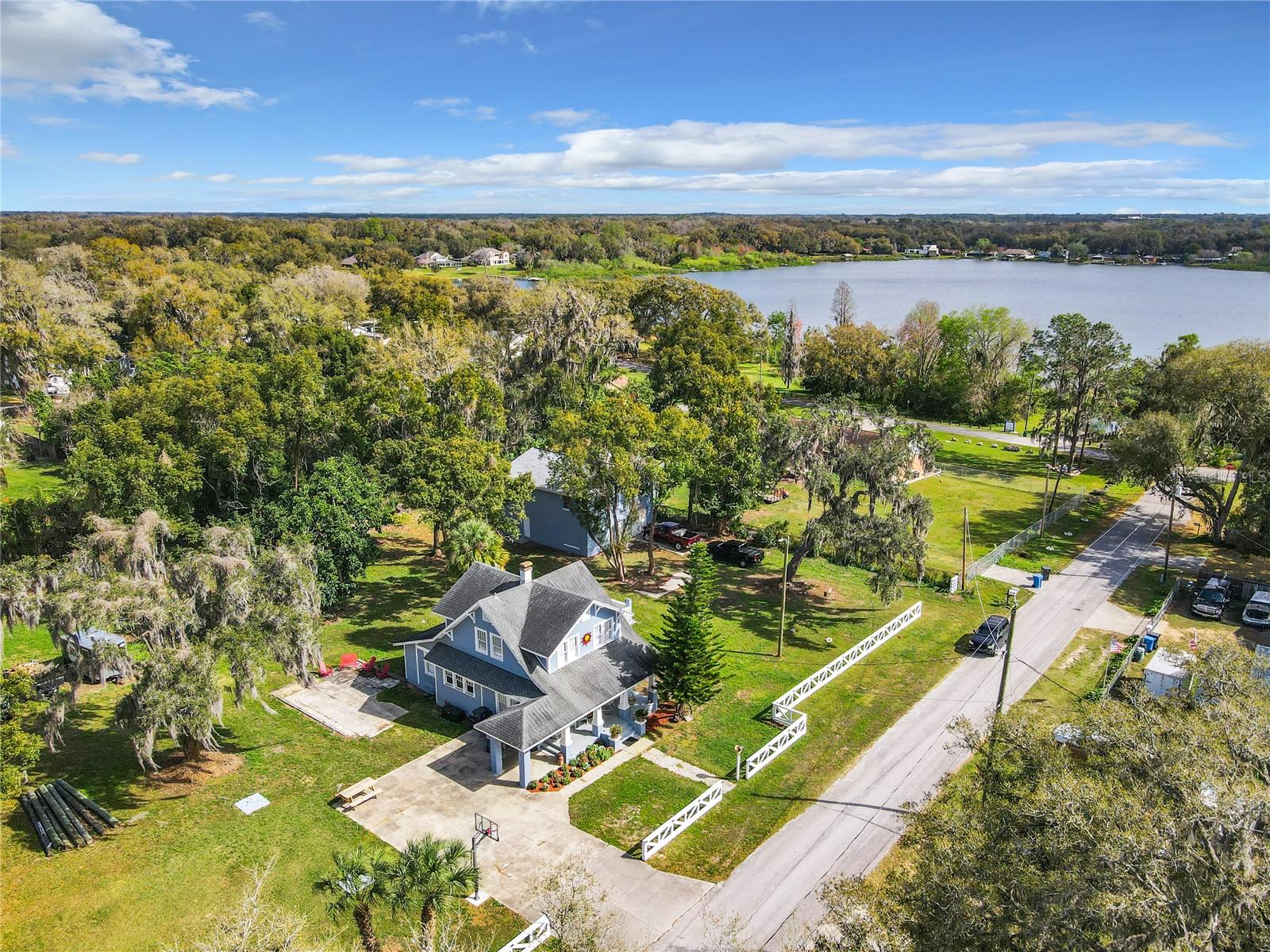 Price Improvement! Situated on a spacious .36-acre lot, this beautifully designed 2-bed, 1.5-bath home offers the perfect blend of comfort, style, and Florida living. Featuring 1,543 square feet of living space, the home welcomes you with an open floor plan, soaring high ceilings, and a cozy fireplace that creates a warm and inviting atmosphere.

The kitchen is designed for both entertaining and everyday living, complete with a large kitchen bar and stunning wrap-around concrete countertops that add a modern custom touch. 

Upstairs, the bedrooms showcase a rustic charm, and with access to the balcony overlooking Lake Weeks, you can enjoy peaceful surroundings with plenty of room to relax and unwind.

Conveniently located near Lake Weeks boat ramp, this property is ideal for outdoor enthusiasts looking to enjoy boating, fishing, and all that Florida waterfront living has to enjoy. With ample space, unique character, NO HOA and NO FLOOD ZONE, this home is a rare opportunity to enjoy privacy, freedom, and convenience all in one.